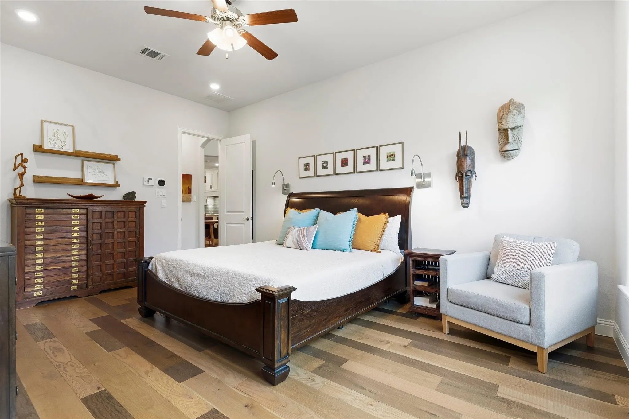 Wood-finish flooring, recessed lighting, and a ceiling fan with integrated lighting