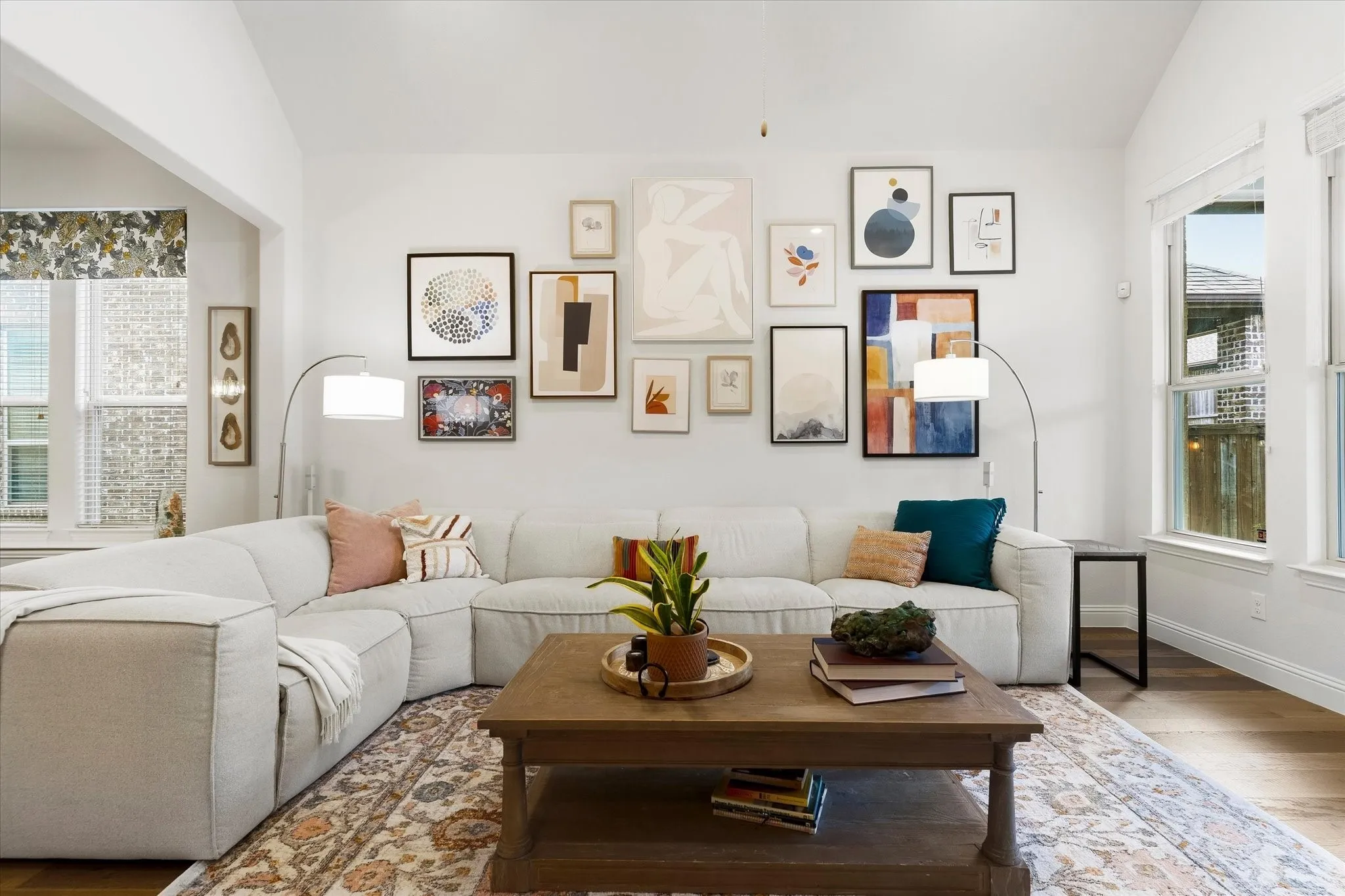 Vaulted ceiling with recessed lighting, wood-finish flooring, and multiple windows