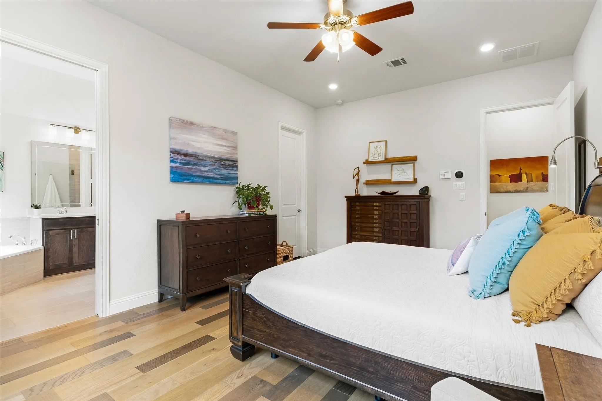 Wood-finish flooring throughout, recessed lighting, and a ceiling fan with integrated lighting