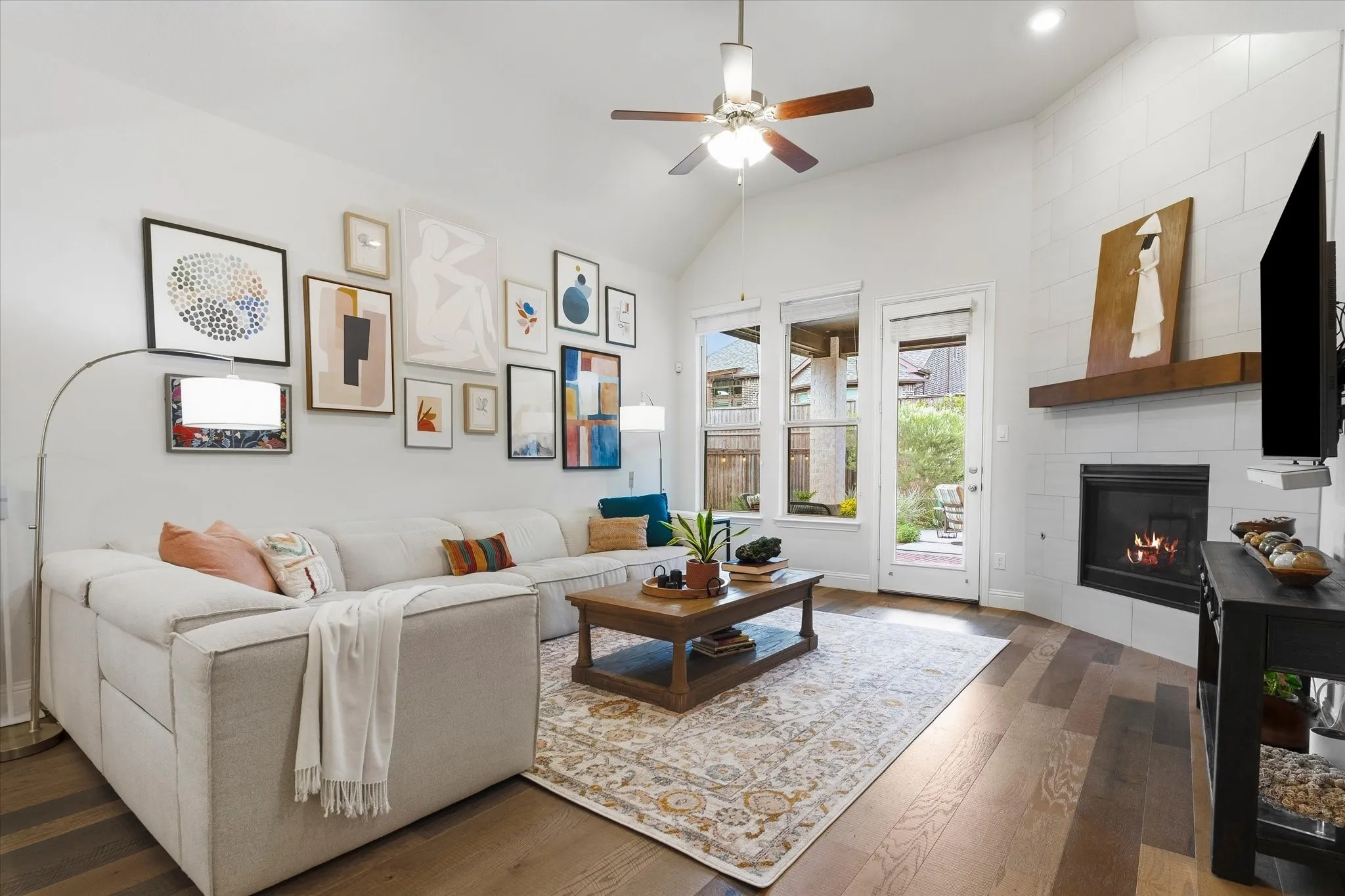 Wood-finish flooring, vaulted ceiling, built-in fireplace, and a wood mantel