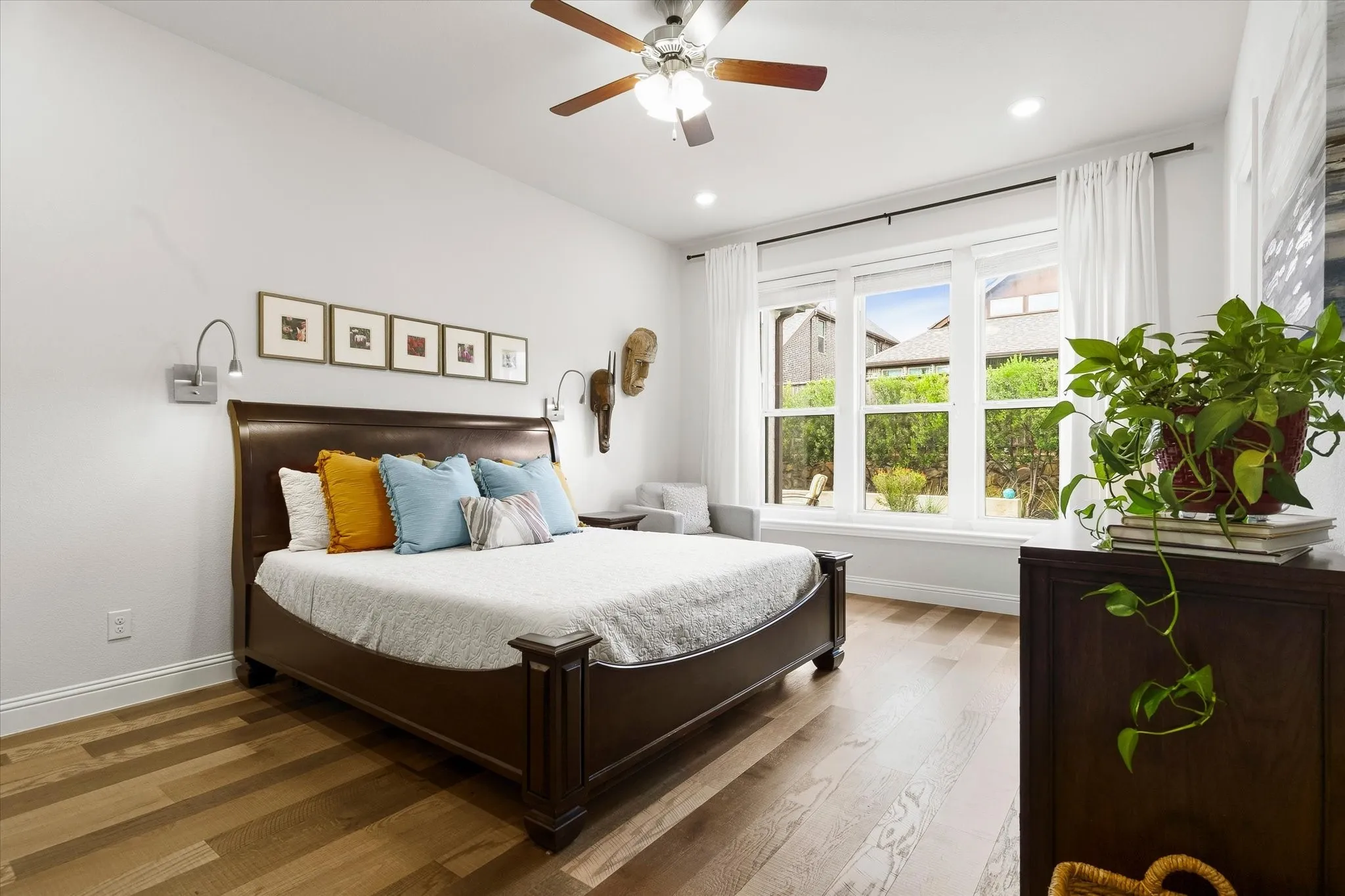 Wood-finish flooring, recessed lighting, and a ceiling fan with light fixture