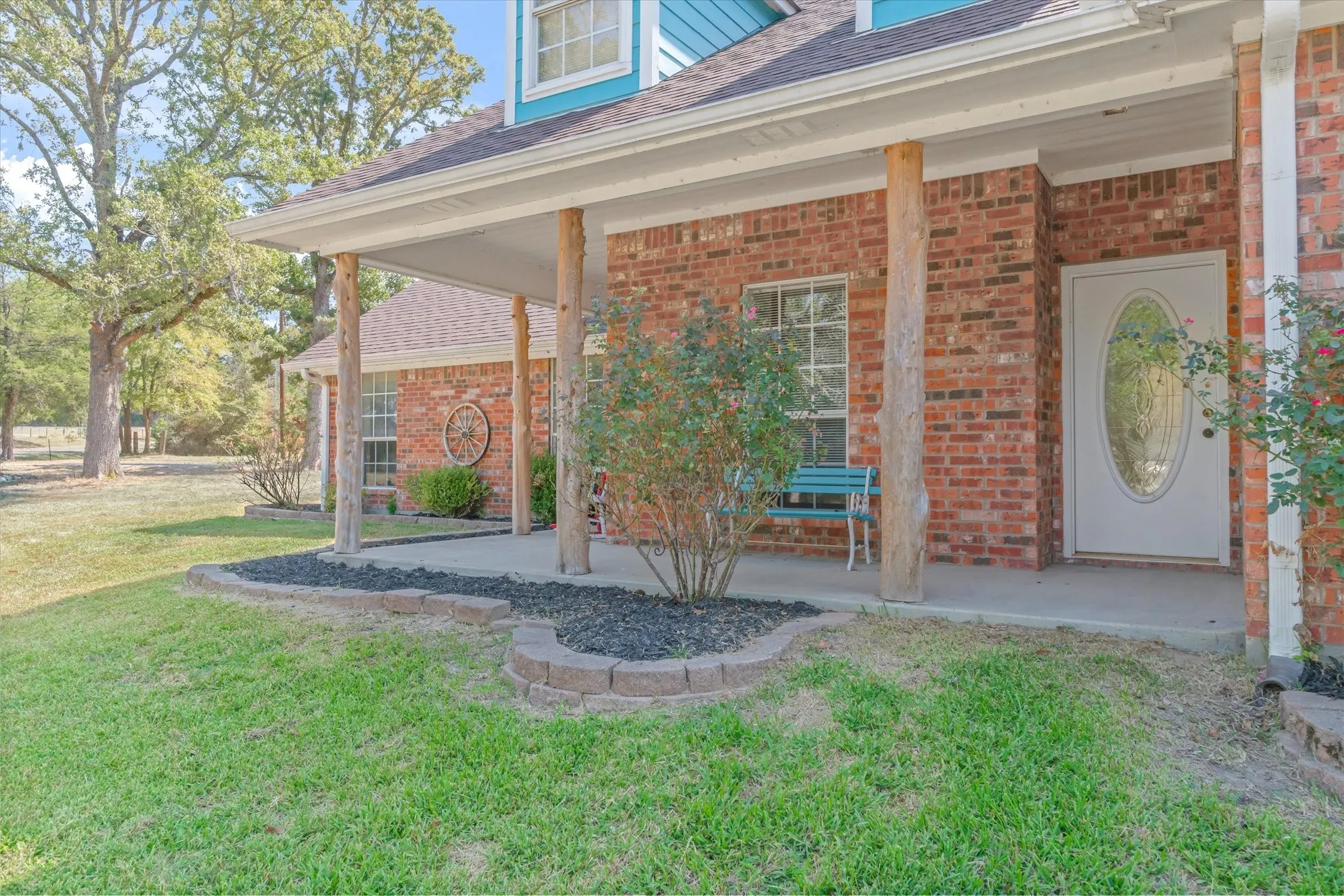 The front of this traditional home has a large porch for enjoying the outdoors