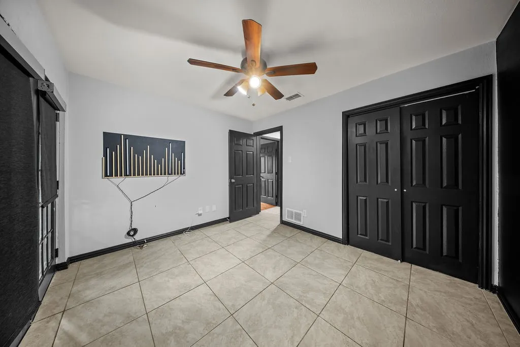 Neutral wall tones complemented by dark trim and doors