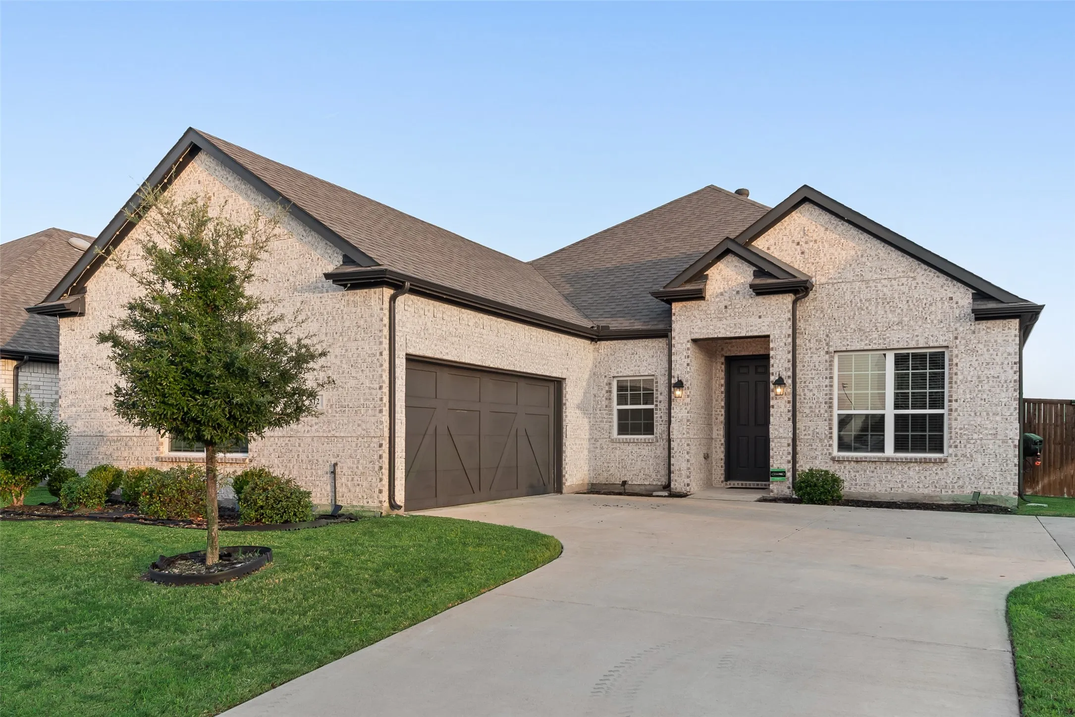 Light brick exterior with dark trim and roof