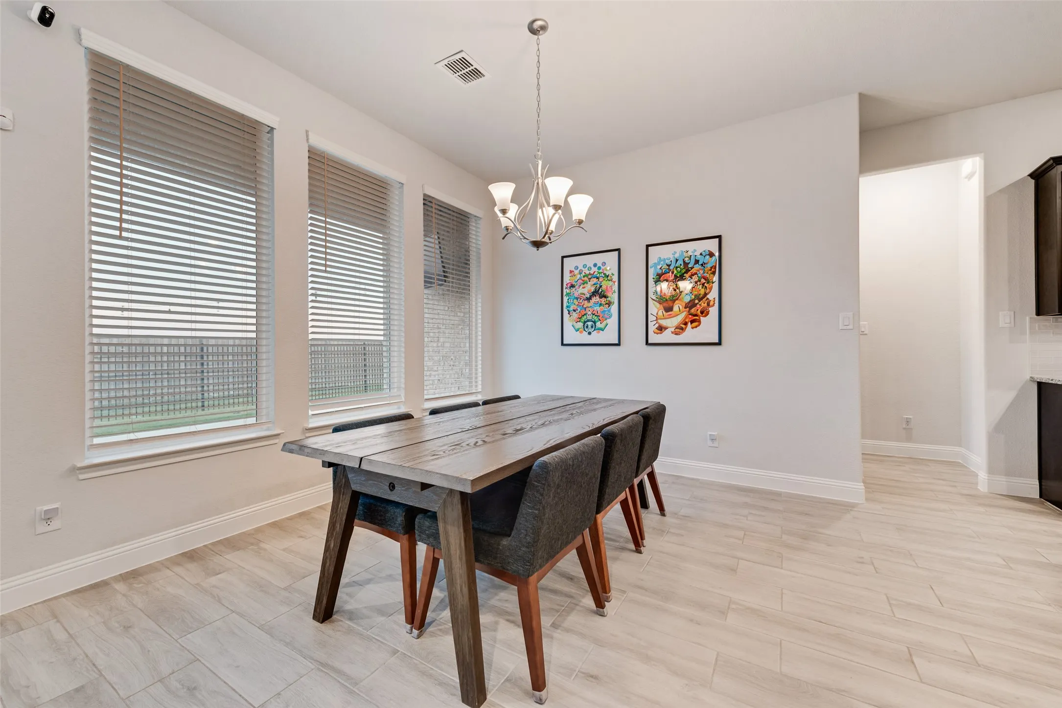 Recessed lighting, wood-finish flooring, and multiple windows with horizontal blinds