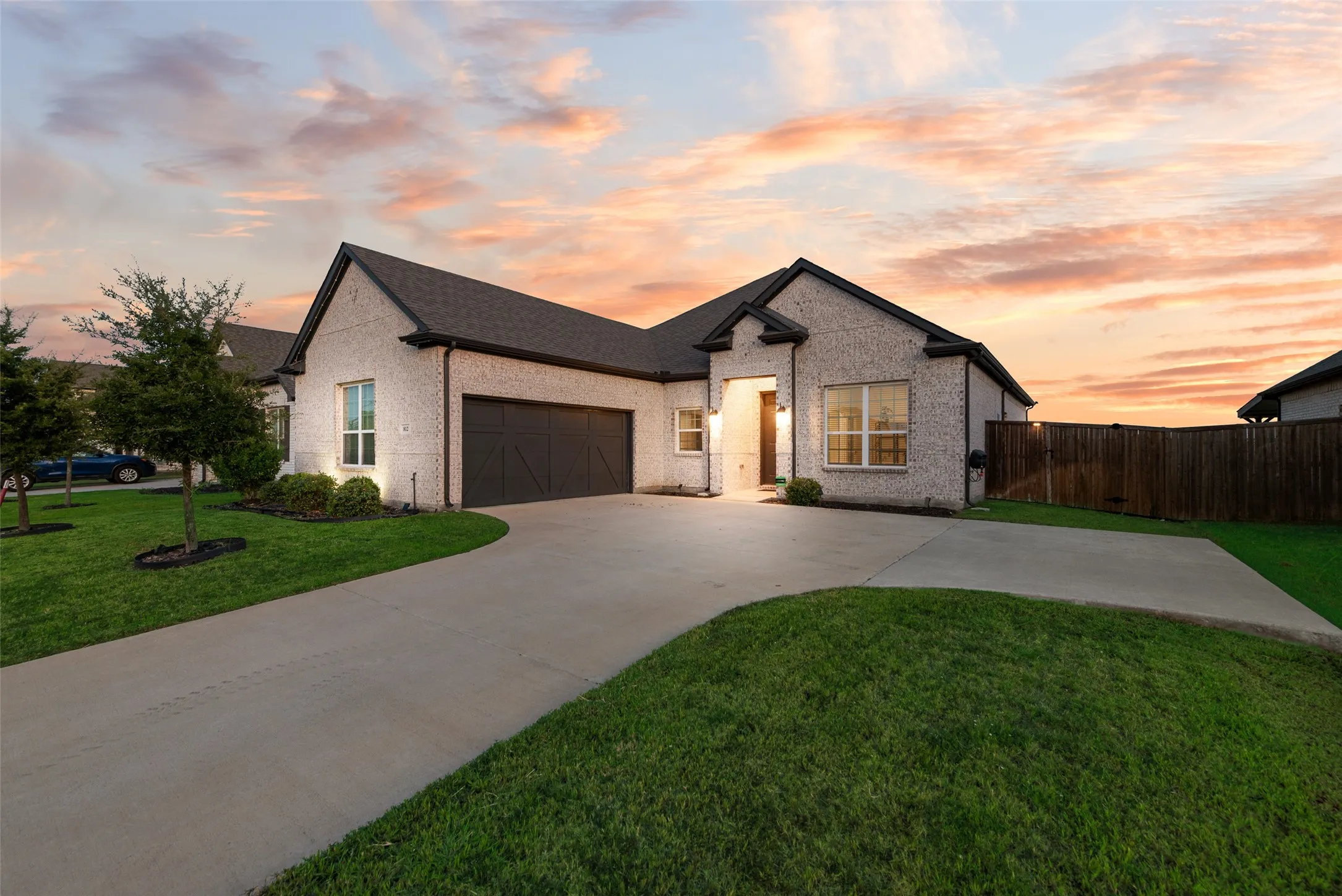 White brick exterior with dark trim and a gabled roofline