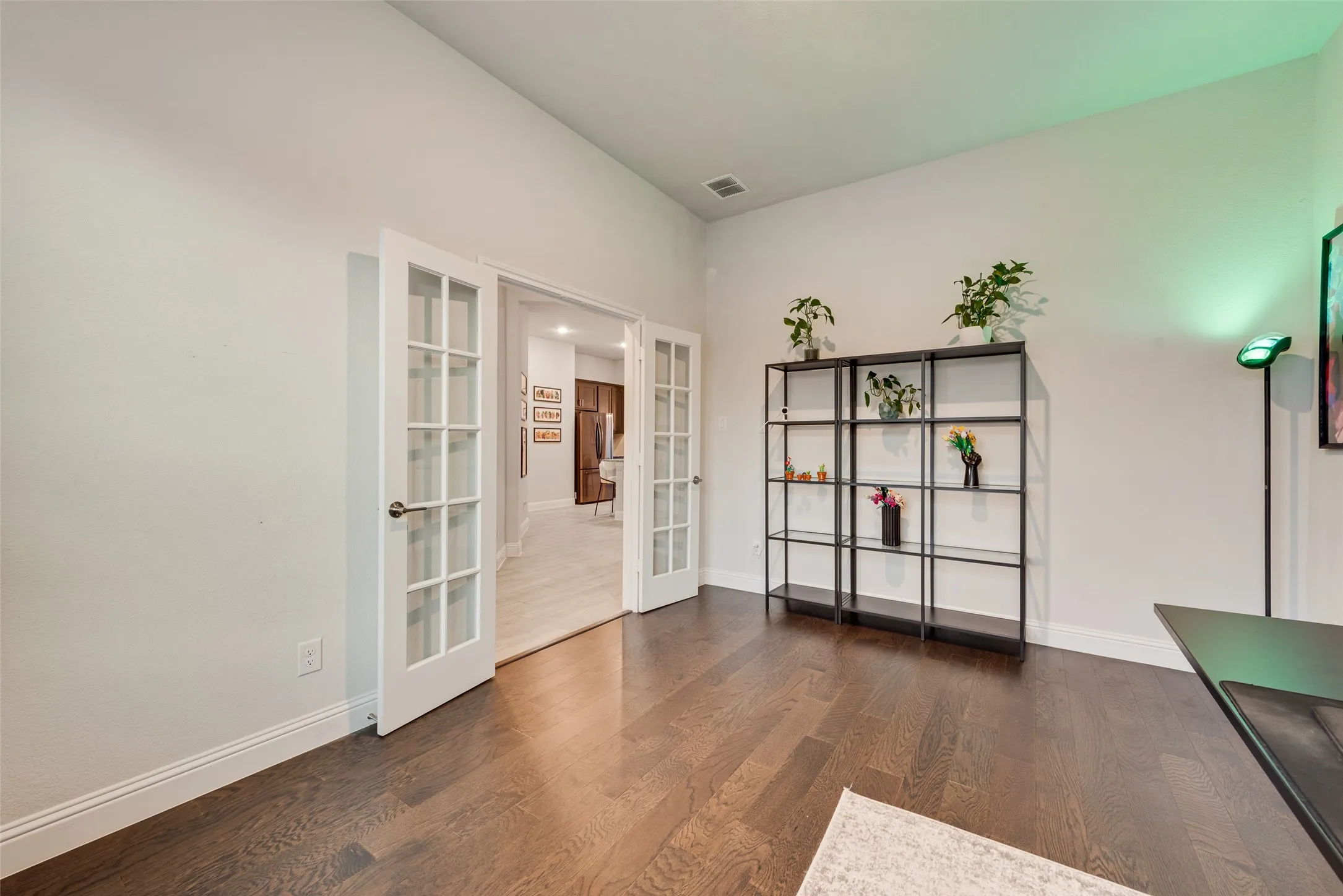 French doors with glass lites, wood-finish flooring, white walls, and recessed lighting