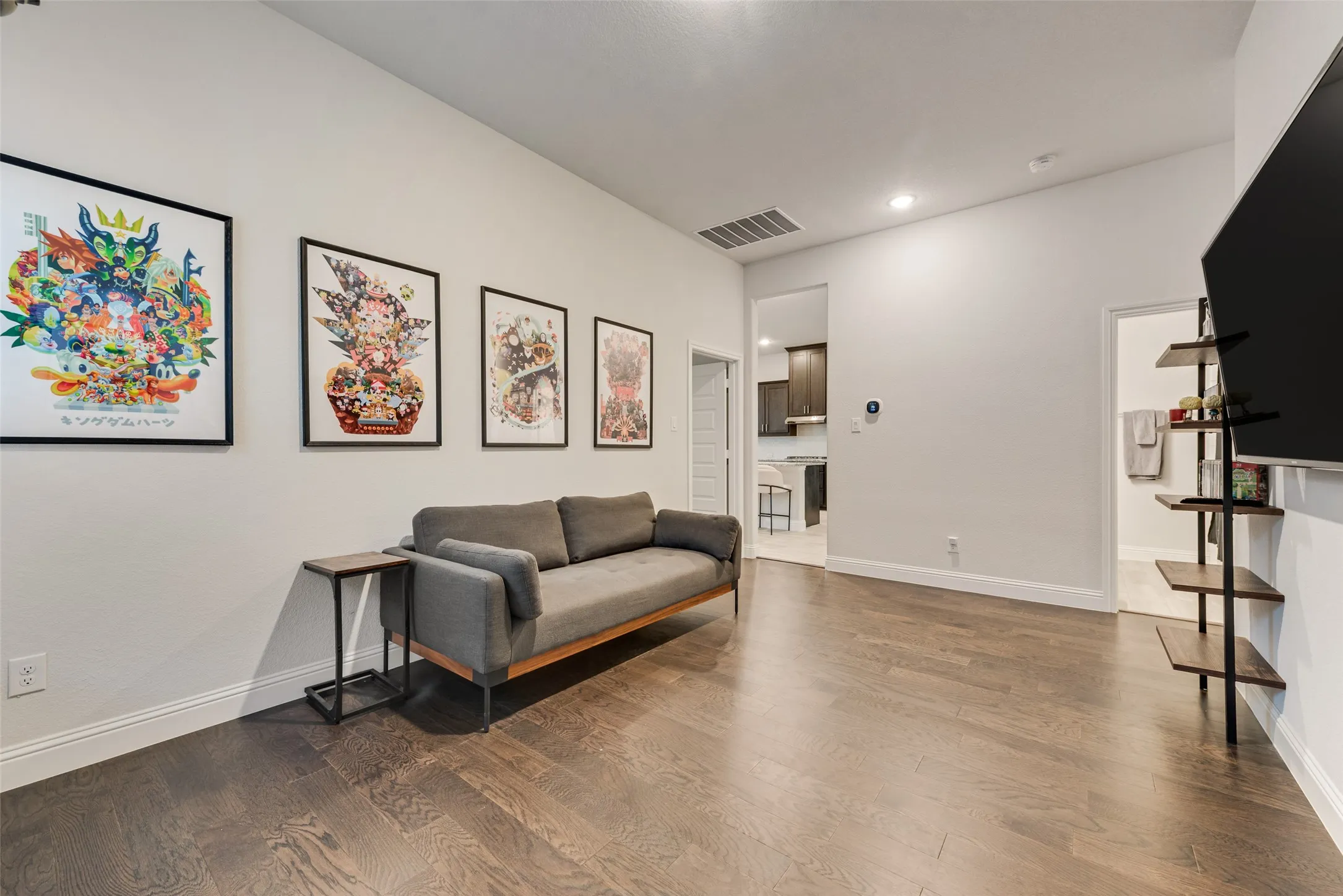 Spacious interior featuring wood-finish flooring, recessed lighting, and a neutral color palette