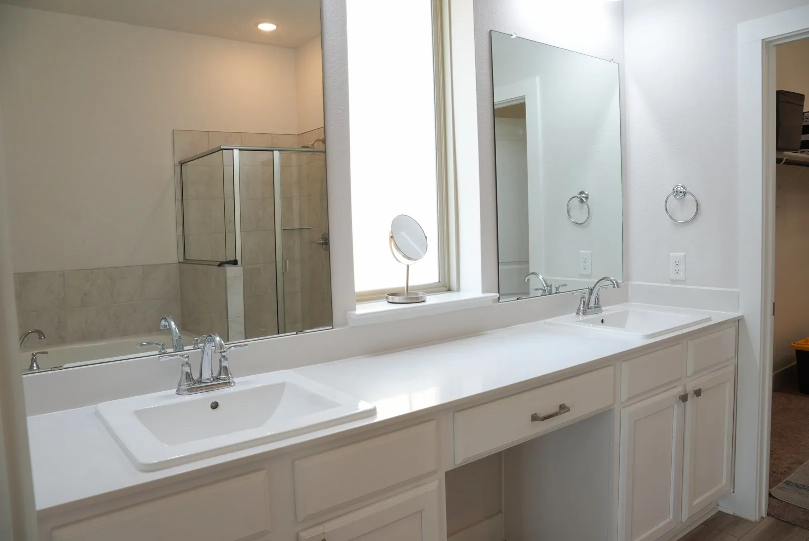 Dual vanity with integrated sinks, white cabinetry, and a spacious countertop
