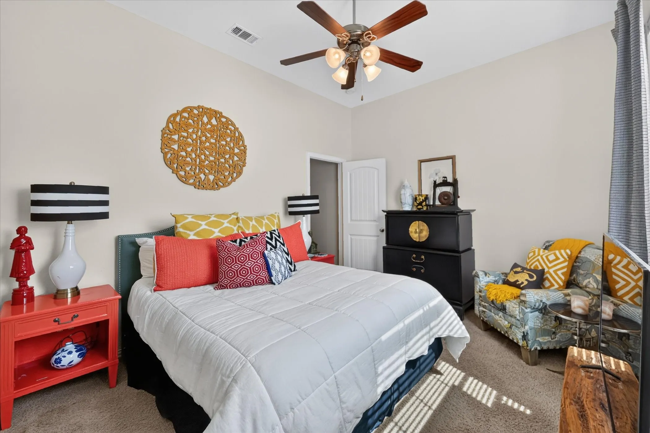 Vaulted ceiling with a ceiling fan, neutral wall paint, and beige carpeting