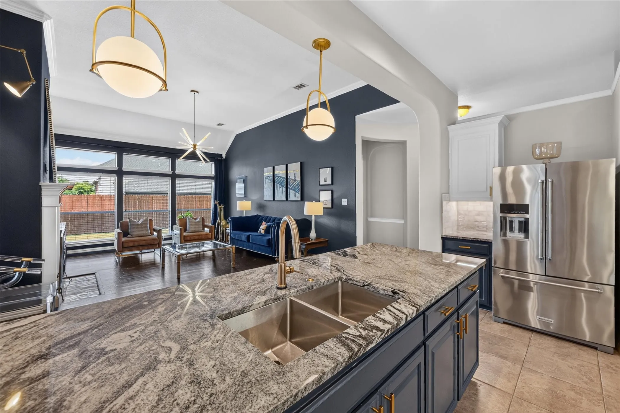 Kitchen island with a double stainless steel sink and stone countertop