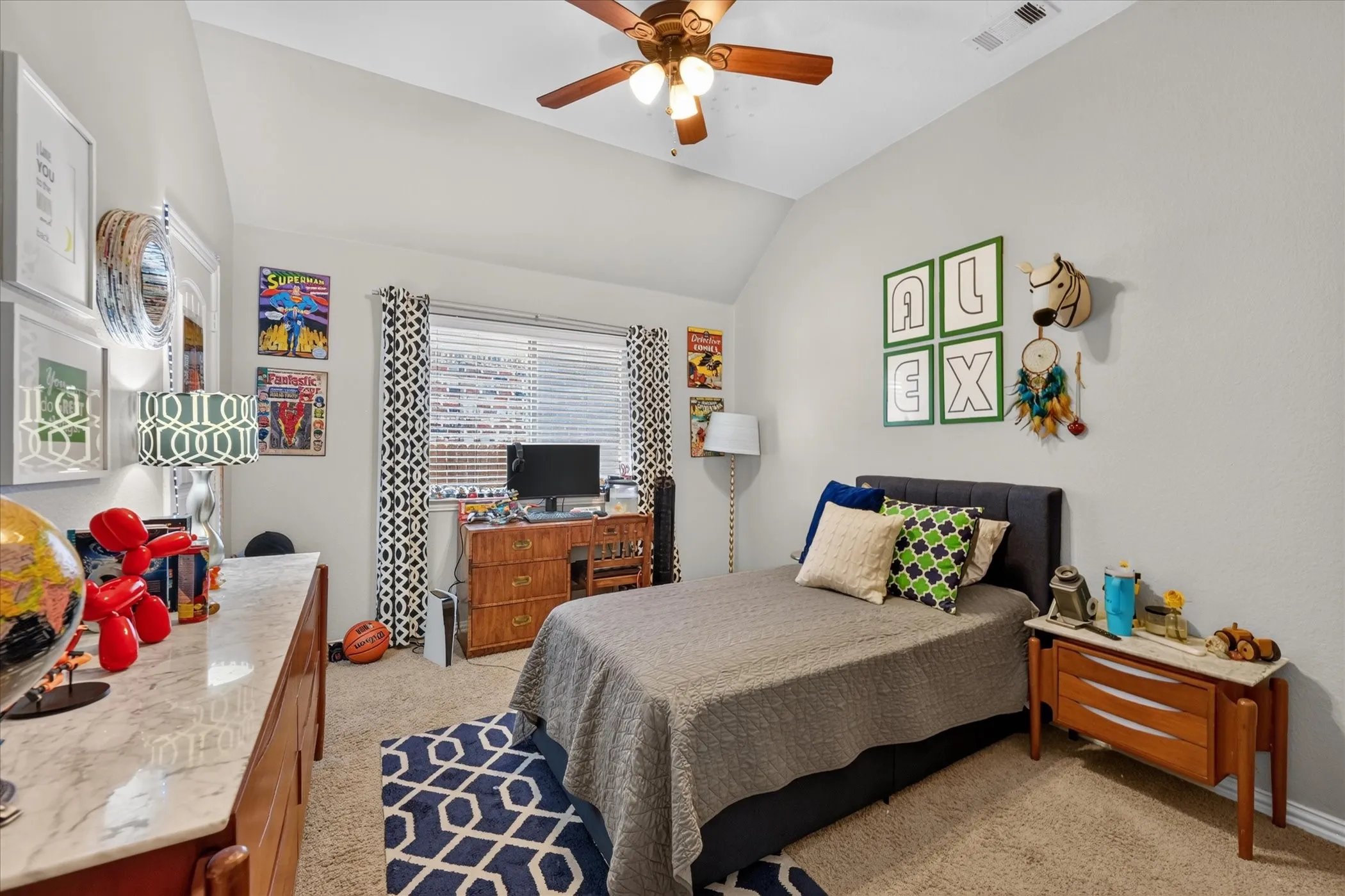 Vaulted ceiling with a ceiling fan, carpeted flooring, window with blinds, and light gray wall paint