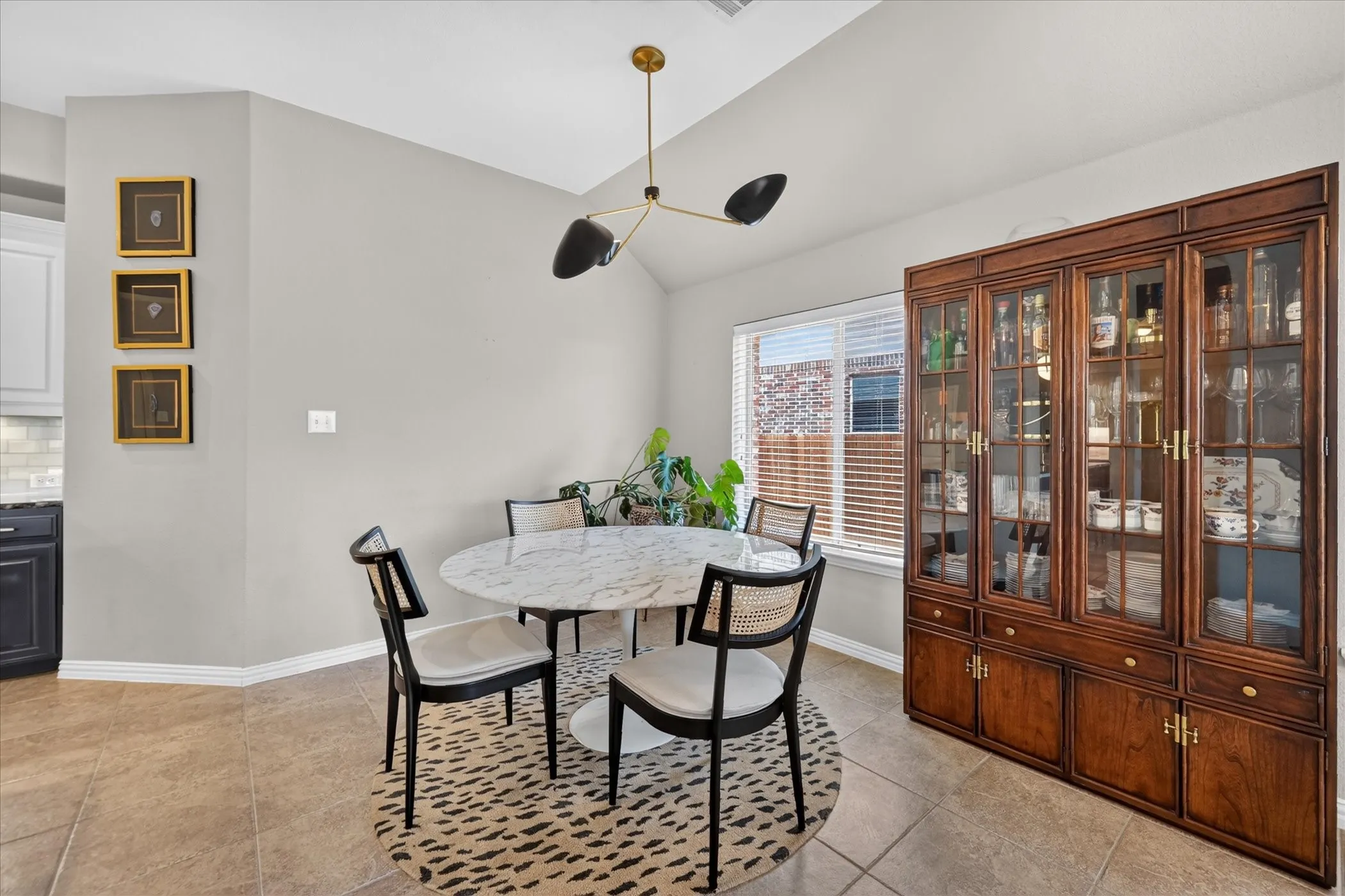 Recessed window with blinds, tile flooring, built-in display cabinetry, and a contemporary light fixture