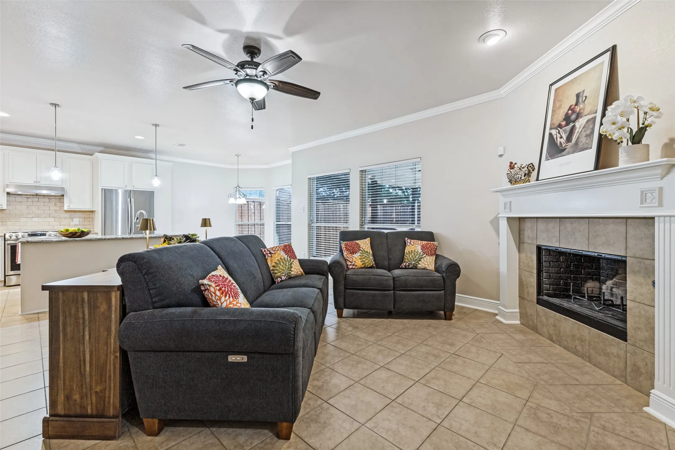Family room with fireplace opens to kitchen