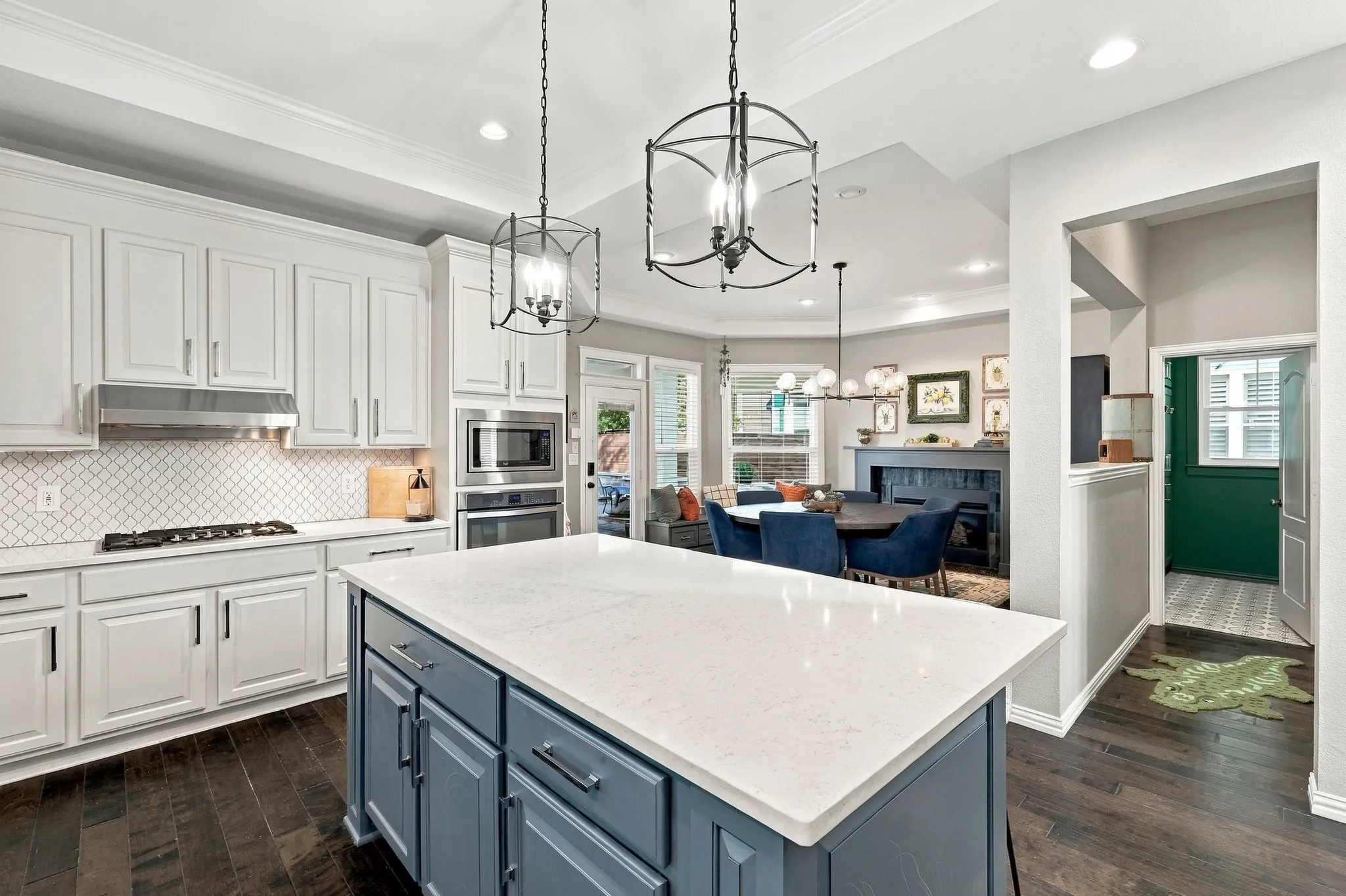 Kitchen leads to dining area and a hall leading to the family room and powder bath