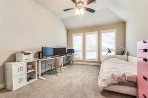 Vaulted ceiling with an integrated ceiling fan, soft gray carpeting, and a wall of three windows with white blinds