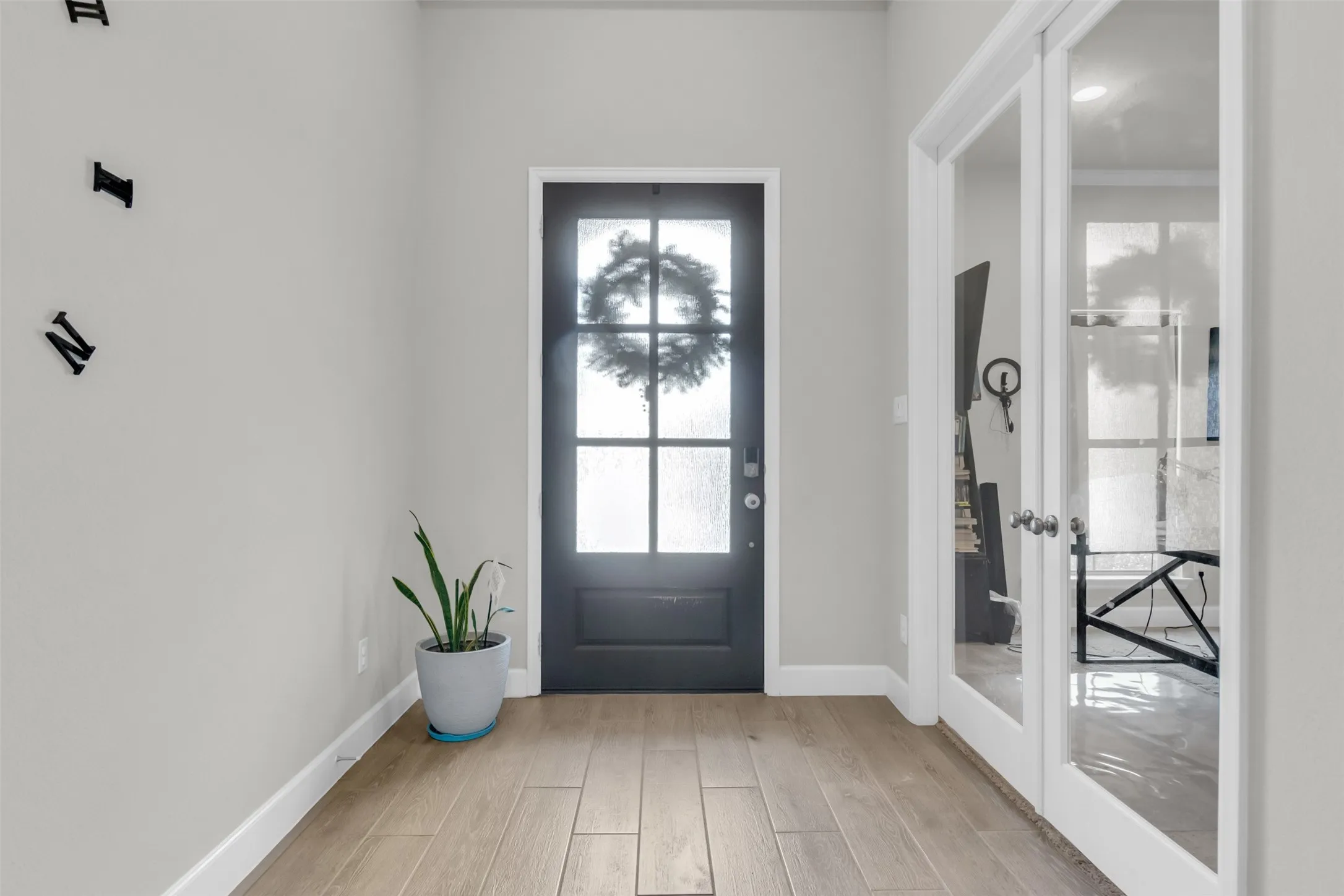 Doorway with french doors and wood finished floors