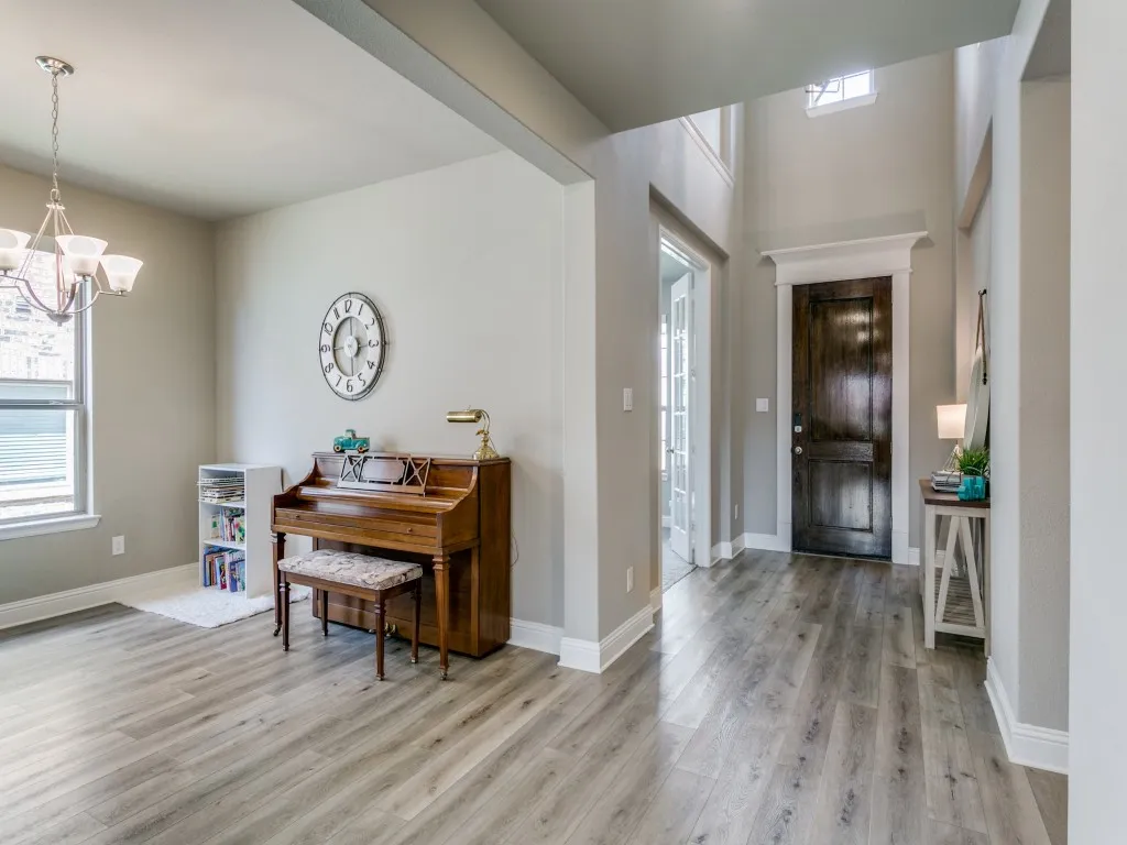 Welcoming foyer featuring soaring ceilings and luxury vinyl plank flooring