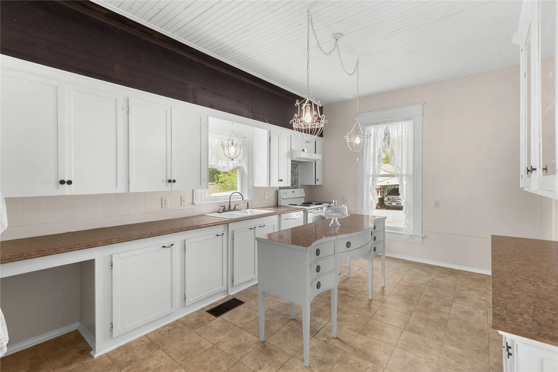 White cabinetry with dark hardware, brown countertops, white beadboard ceiling, tiled flooring, and a white appliance suite