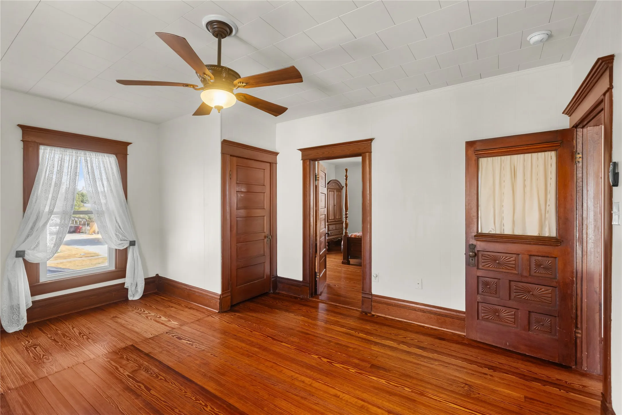 Hardwood flooring, wood trim, wood paneled ceiling, ceiling fan, solid wood doors