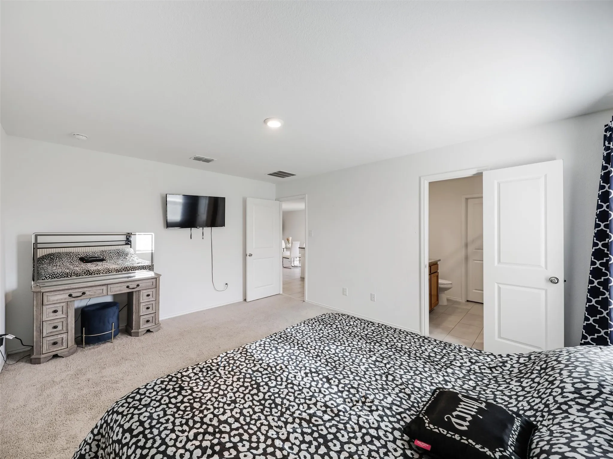 Carpeted flooring, recessed lighting, and a white interior door