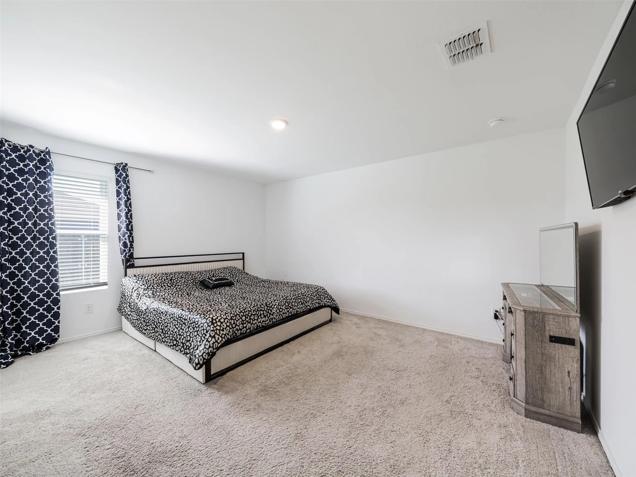 Recessed lighting and carpeted flooring enhance this space