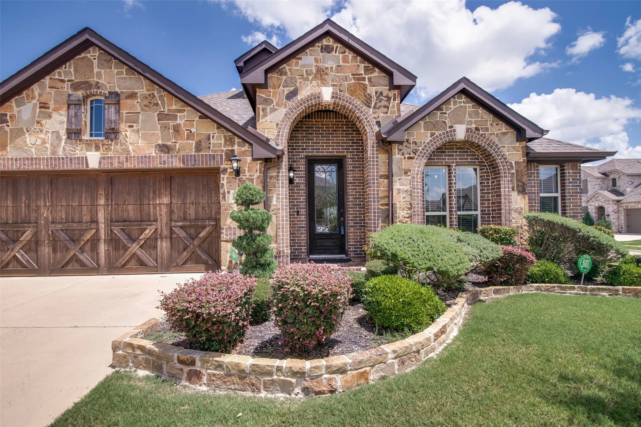 Stone and brick exterior with arched windows and entry