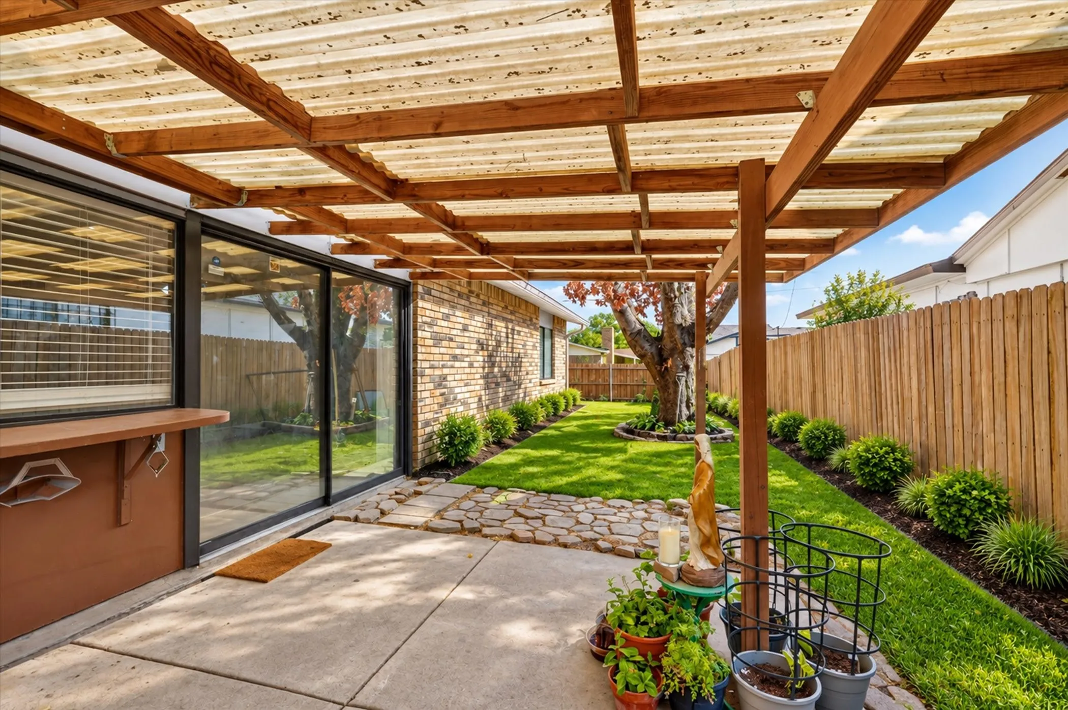 Covered patio. Grass and landscaping is digitally altered.
