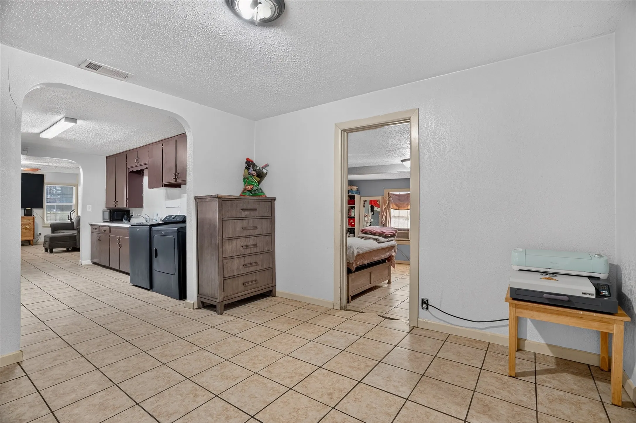 White walls complement the light-toned tile flooring