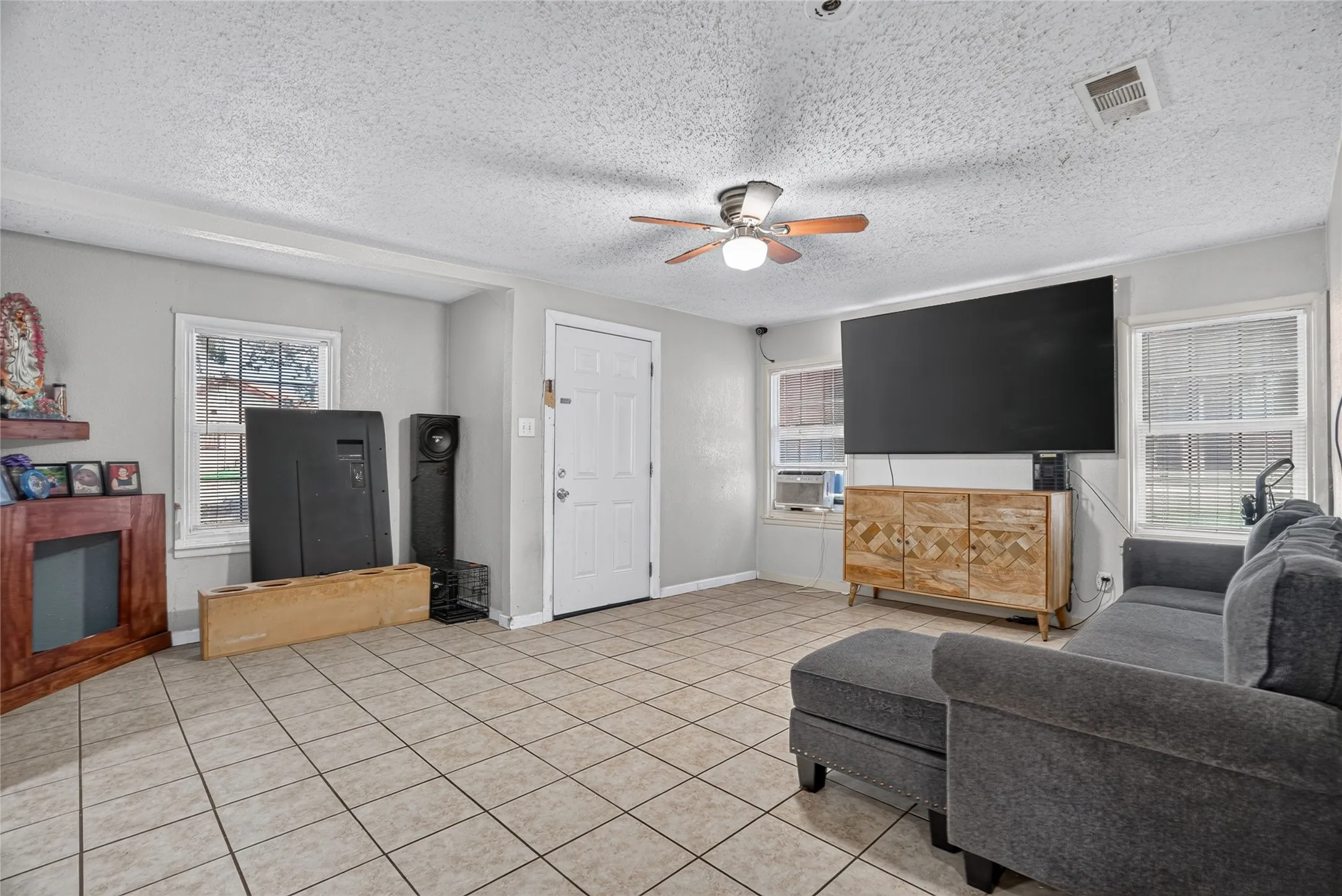 Tile flooring, ceiling fan, multiple windows, built-in shelving