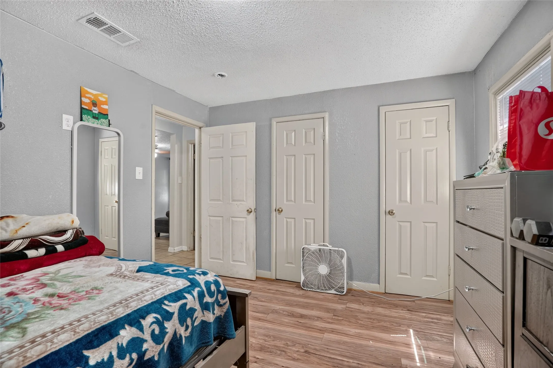 Wood-finish flooring with light gray walls and white trim