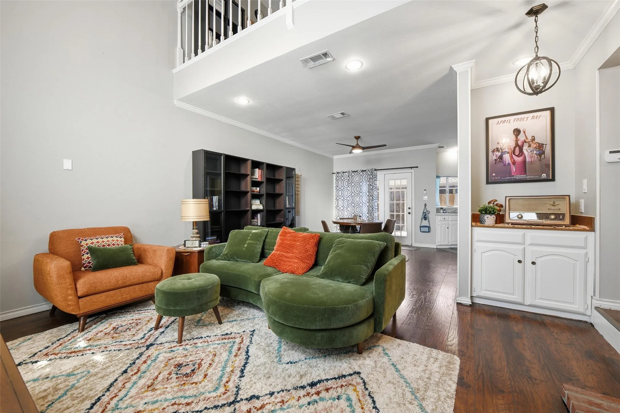 Vaulted ceilings, wood-finish flooring, built-in cabinetry, overhead lighting, and an open-concept design