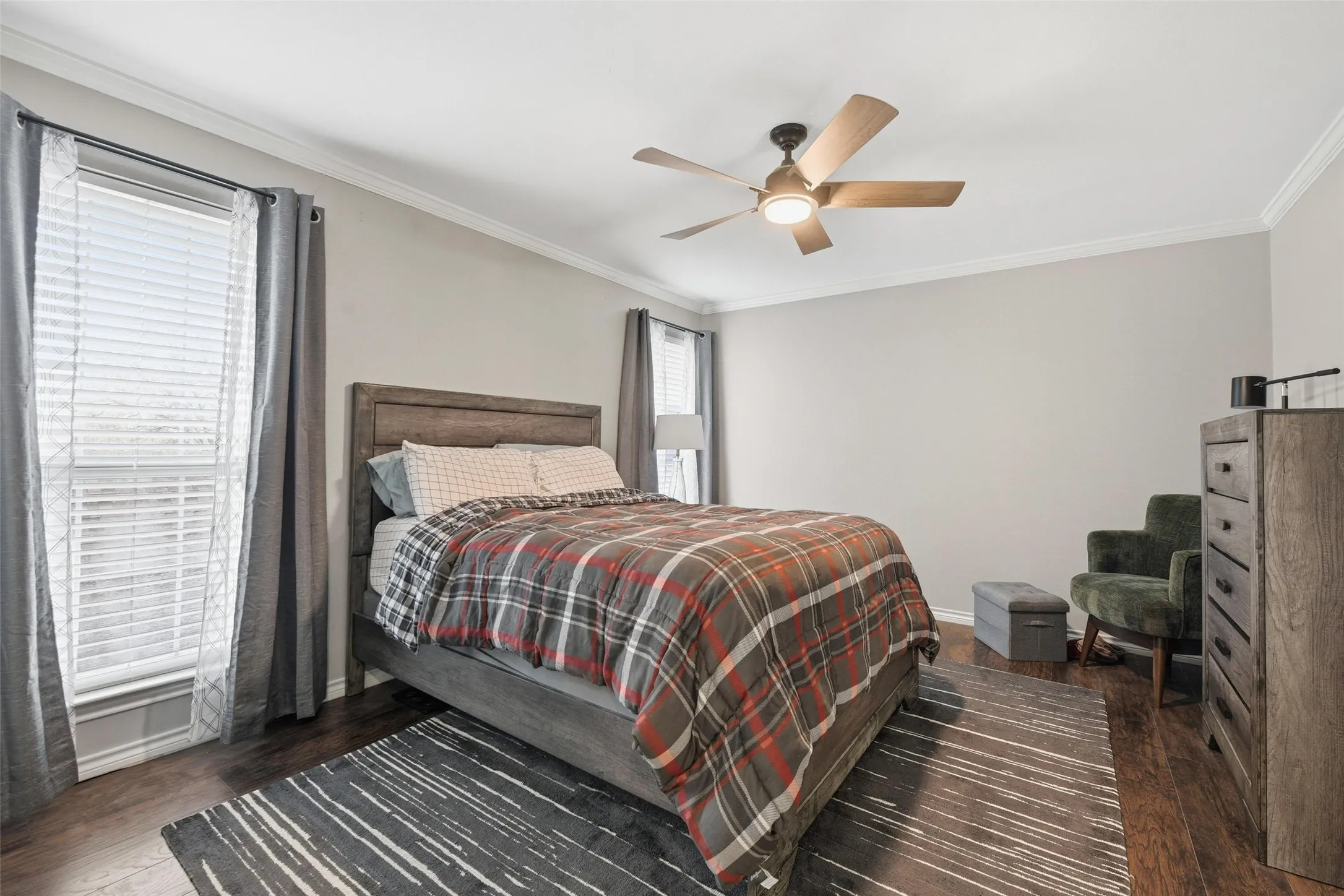 Crown molding, wood-finish flooring, ceiling fan with integrated lighting, window with blinds, and neutral wall tones