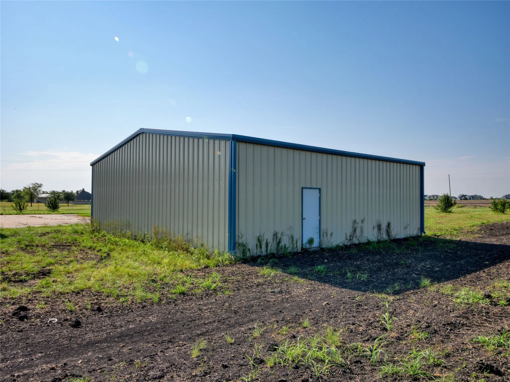 Freestanding metal building with a single entry door and perimeter trim