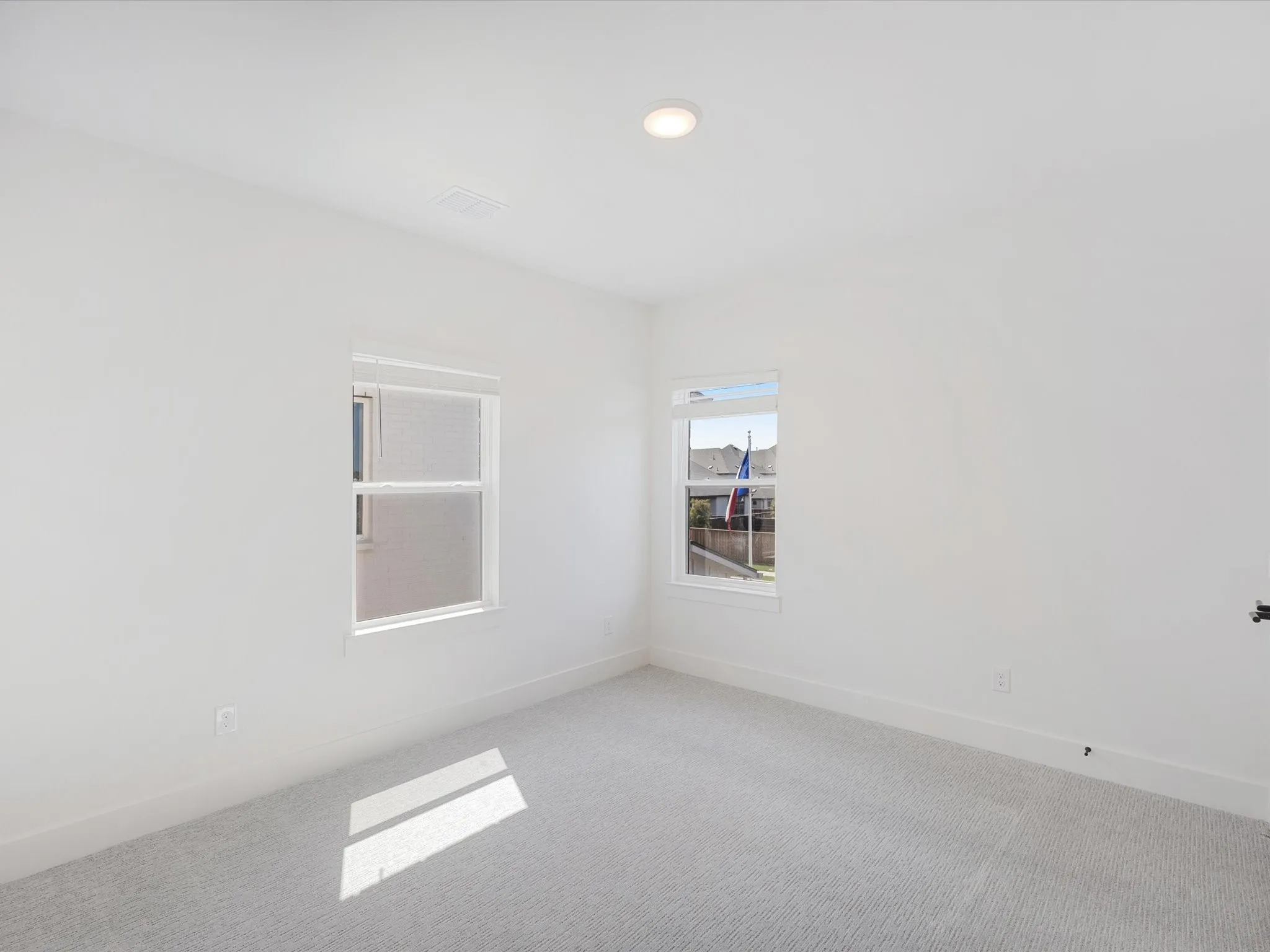 Empty room with carpet and recessed lighting
