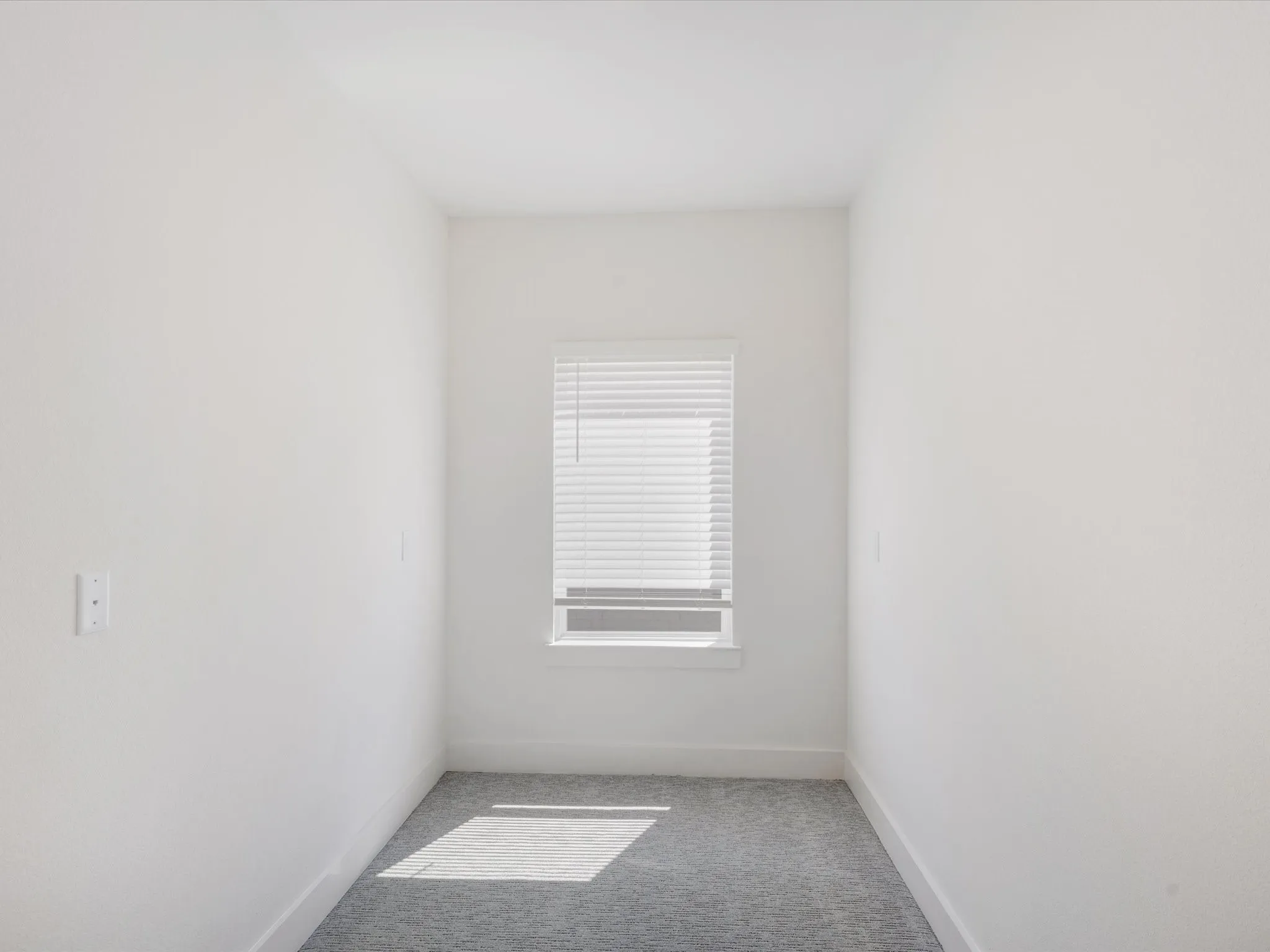 Empty room with carpet and baseboards