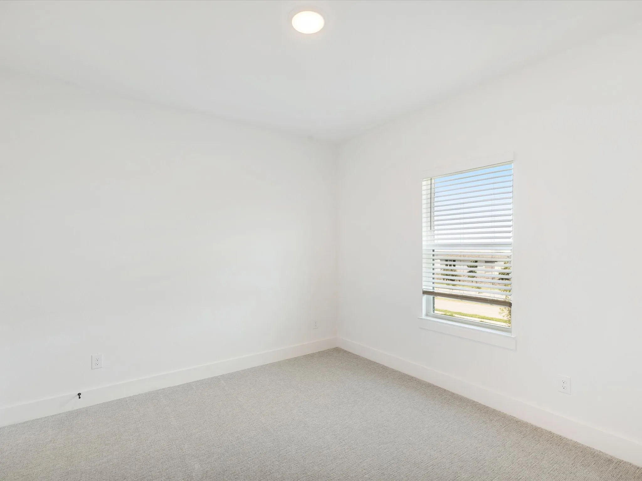 Spare room featuring carpet flooring and recessed lighting