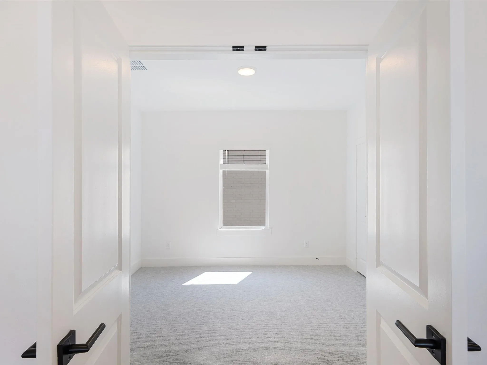 Spare room featuring light carpet and recessed lighting