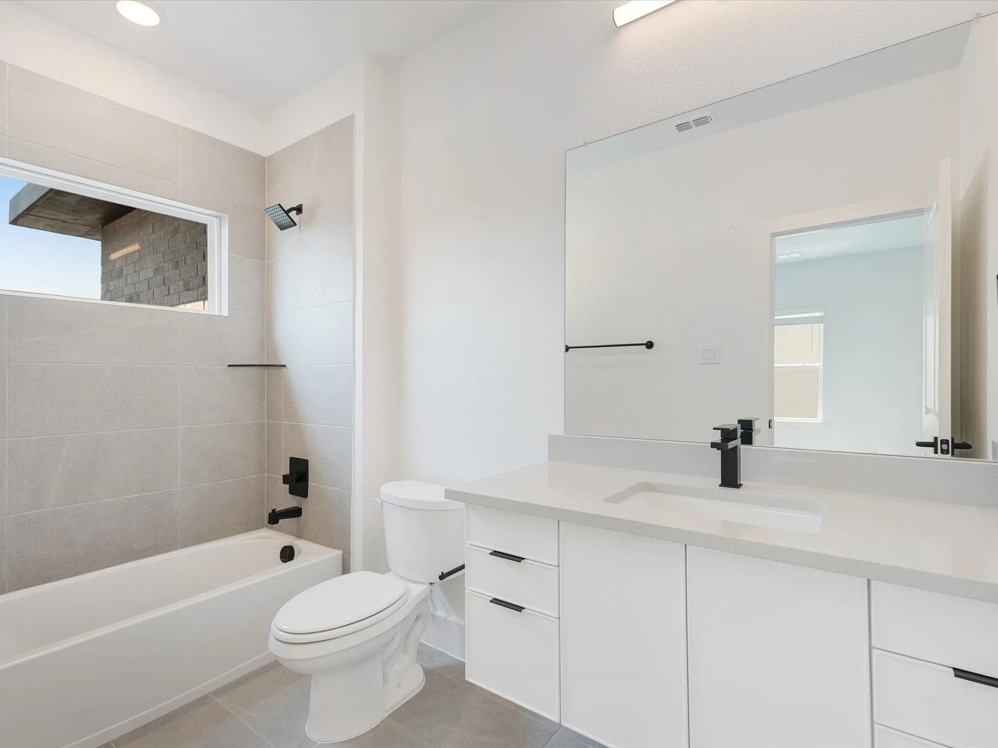 Full bath with tub / shower combination, vanity, light tile patterned floors, and recessed lighting