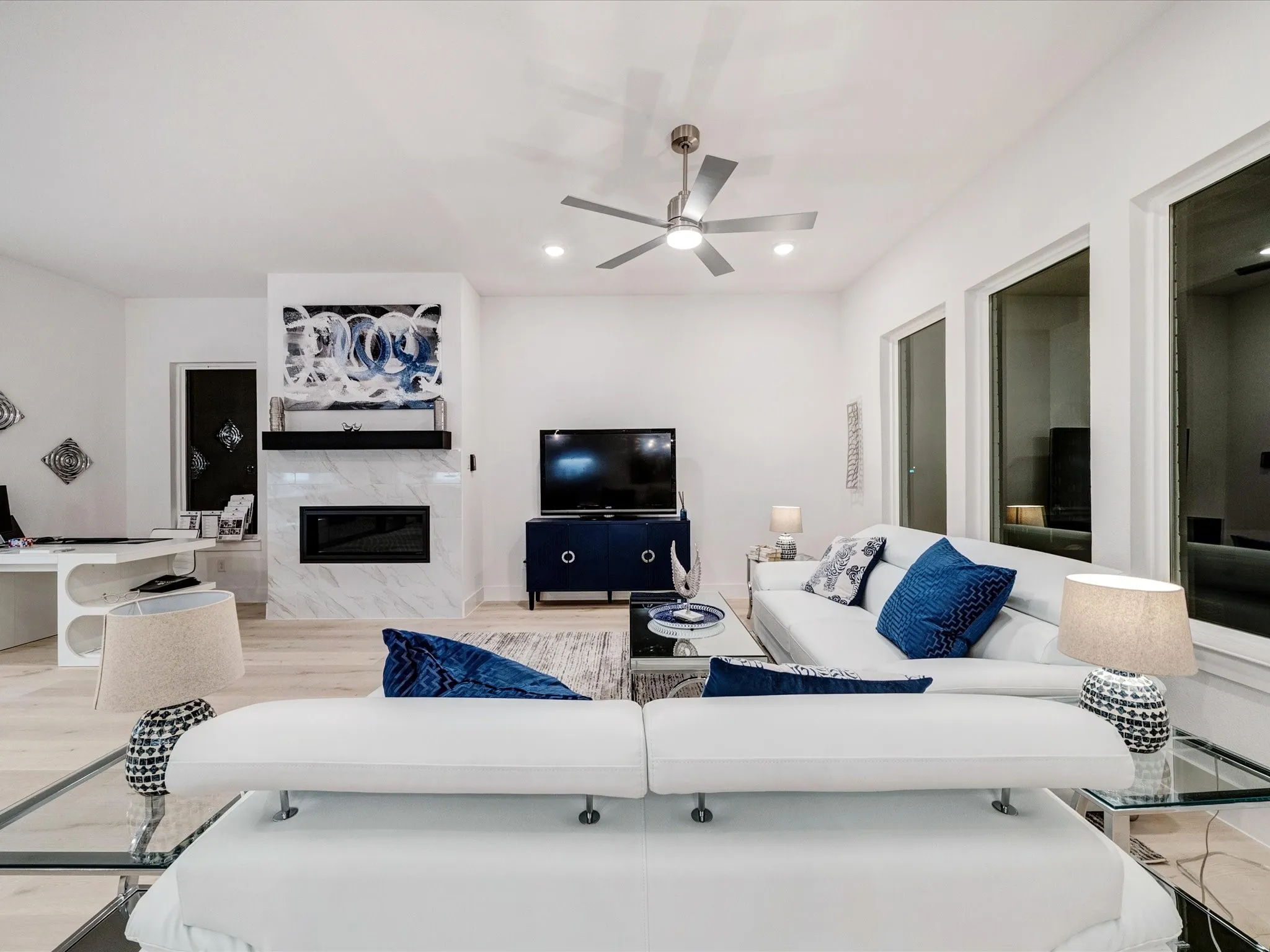 Living area featuring a premium fireplace, recessed lighting, light wood-type flooring, and ceiling fan