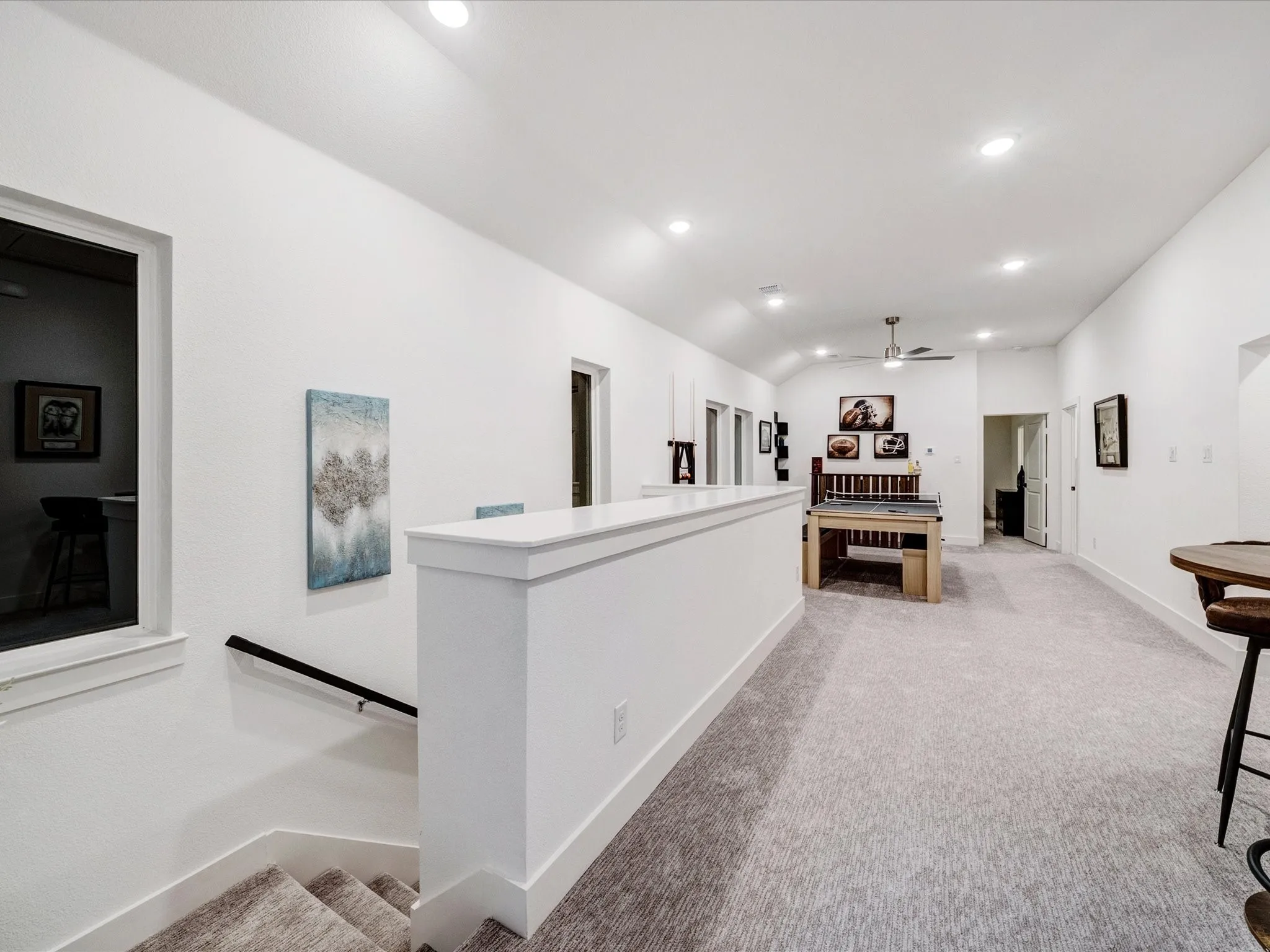 Hall with recessed lighting, light carpet, lofted ceiling, and an upstairs landing