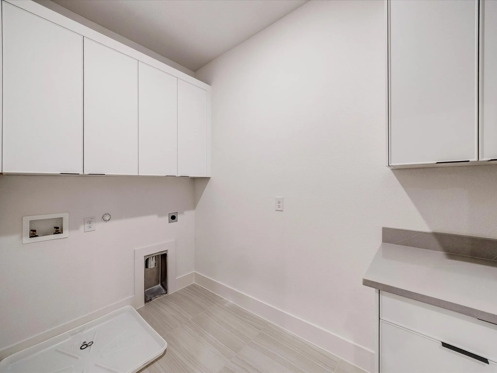 Laundry area featuring gas dryer hookup, cabinet space, electric dryer hookup, and hookup for a washing machine