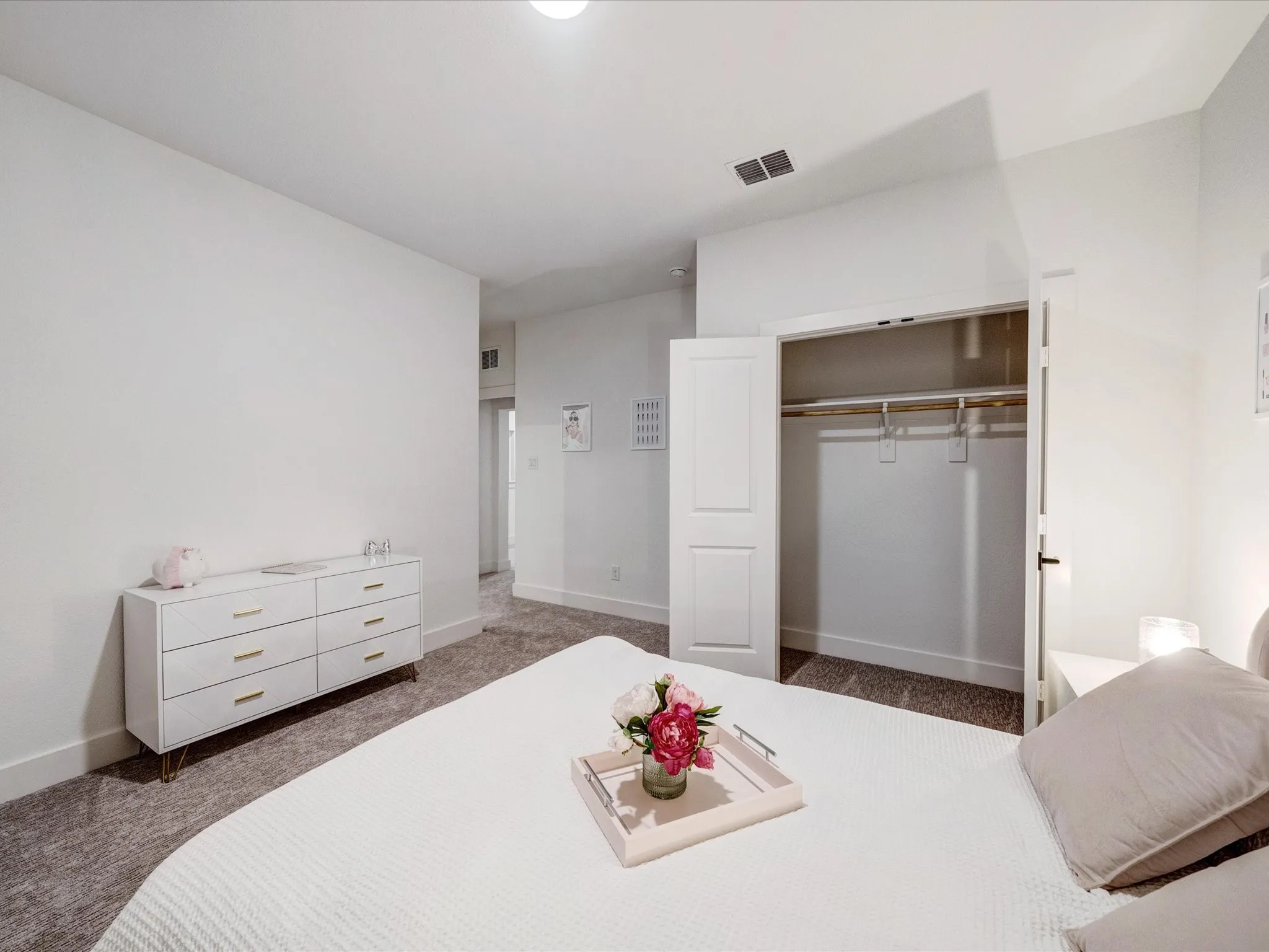 Bedroom with dark colored carpet and a closet