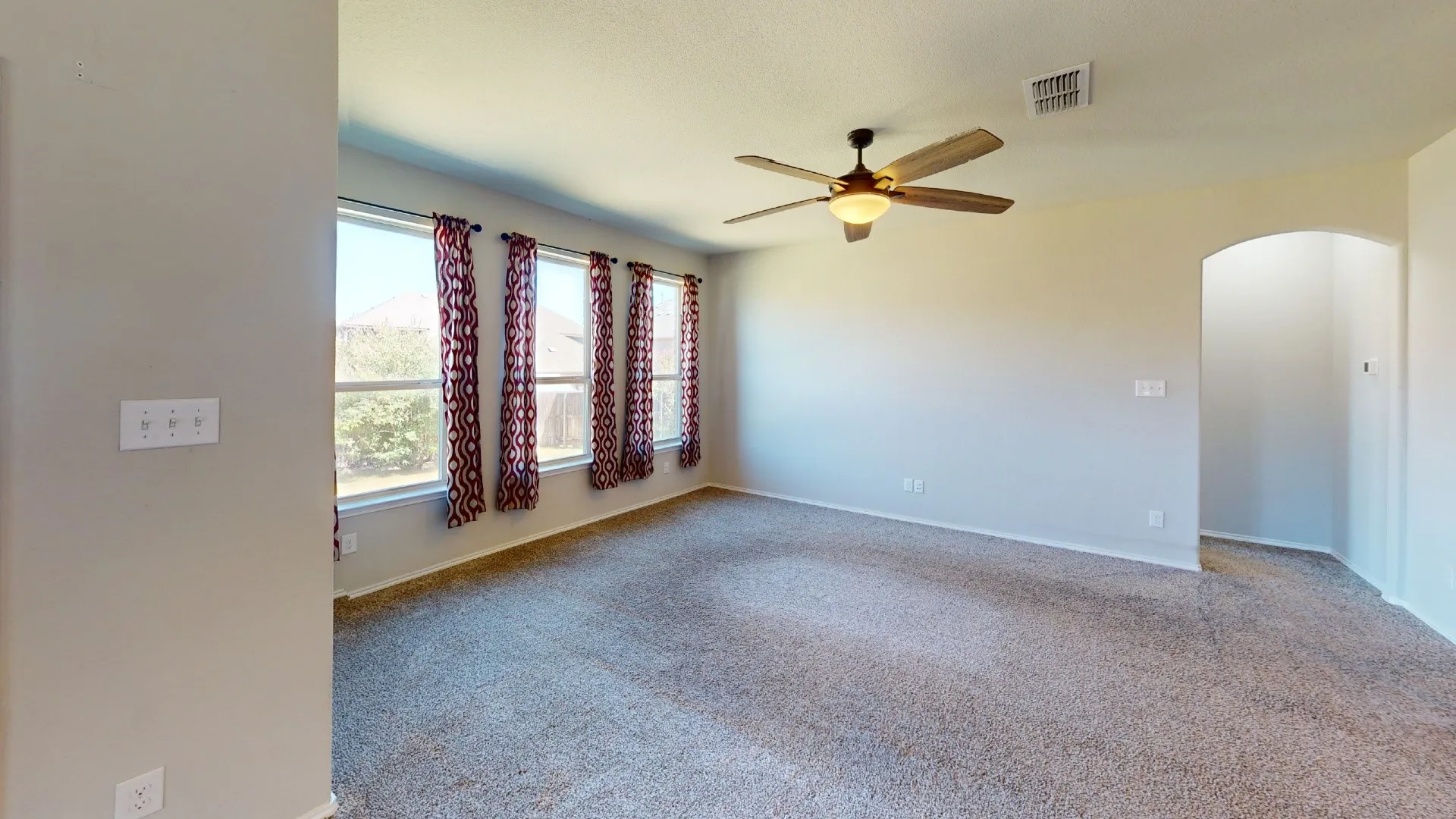 Recessed windows, ceiling-mounted light fixture, and arched entryway