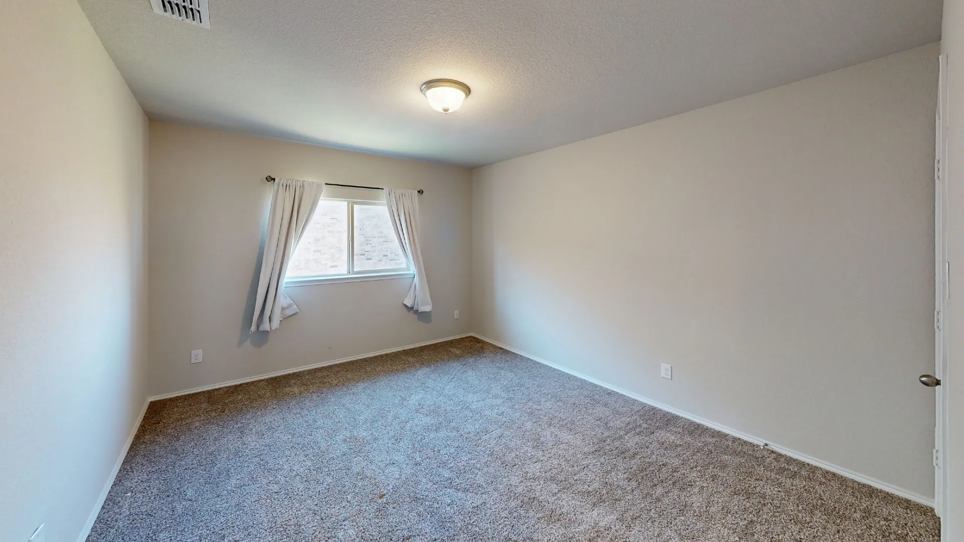 Window with white trim and curtains, neutral wall tones, and carpeted flooring