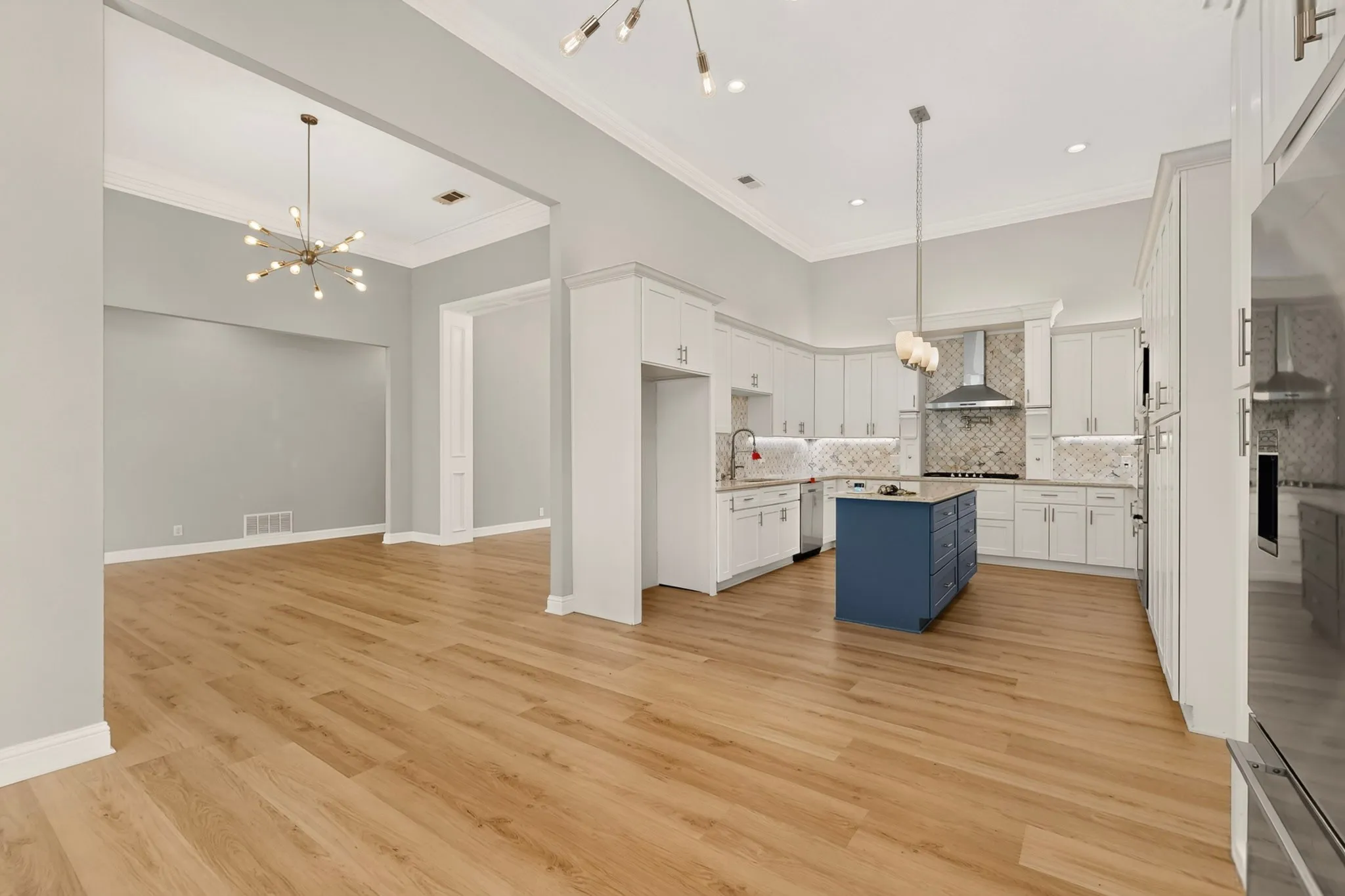 Light wood-finish flooring, recessed lighting, and crown molding