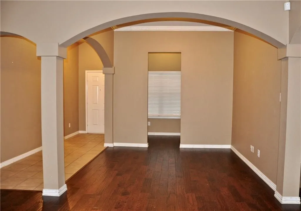 Welcome home! Elegant wood flooring and architectural arches greet you right at the front door.