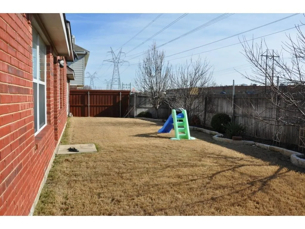 Brick exterior and a wooden privacy fence