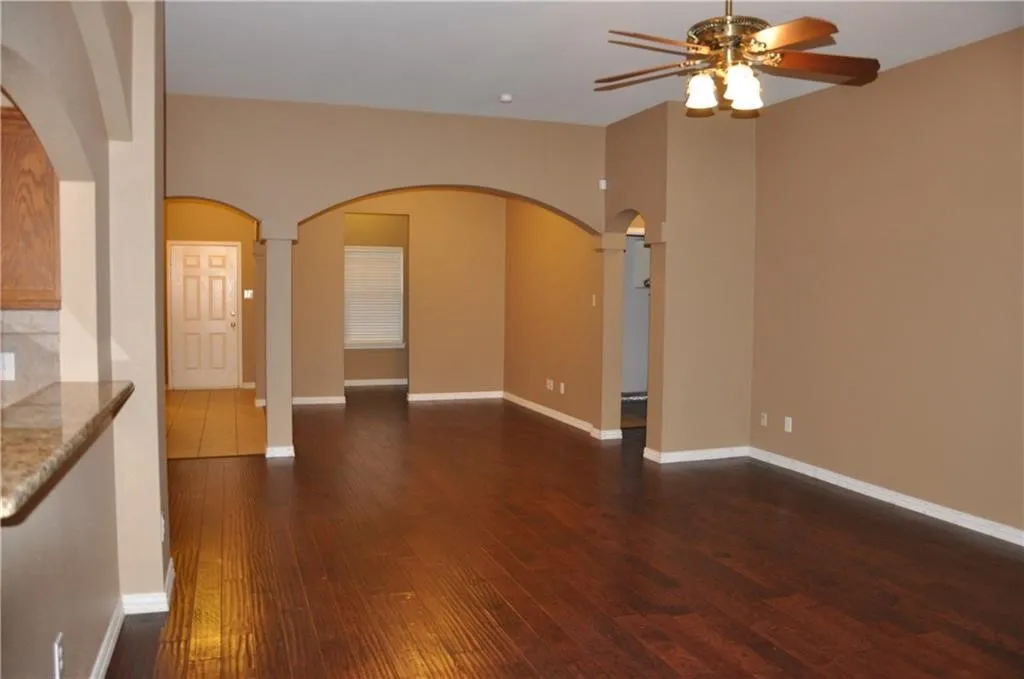 Versatile living and dining spaces framed by beautiful crown molding and custom arches