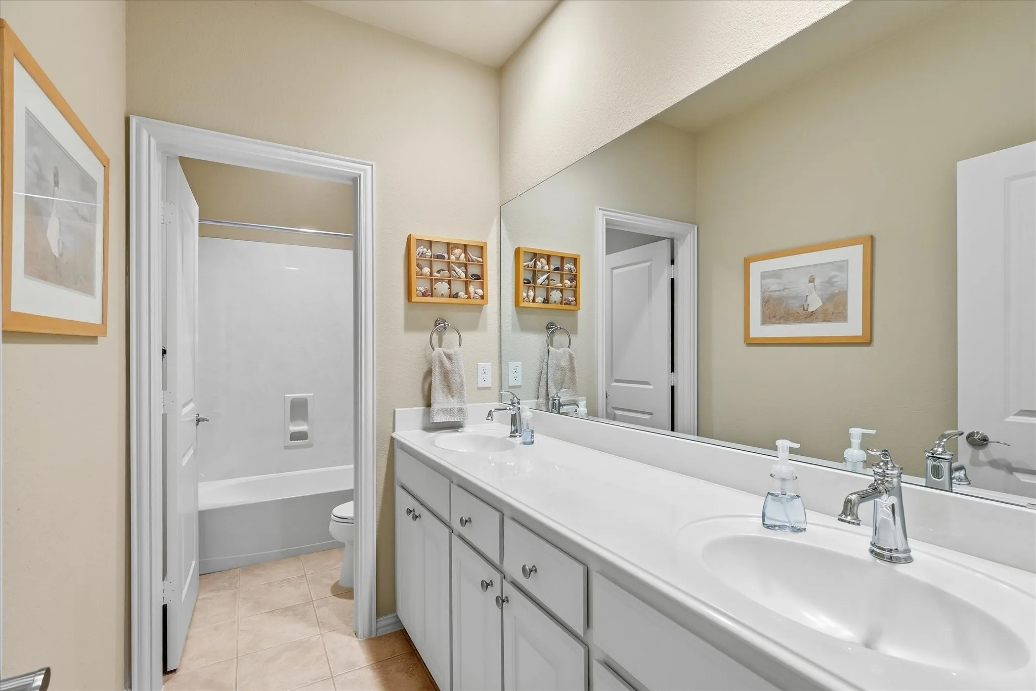 Dual vanity with white cabinetry and chrome fixtures